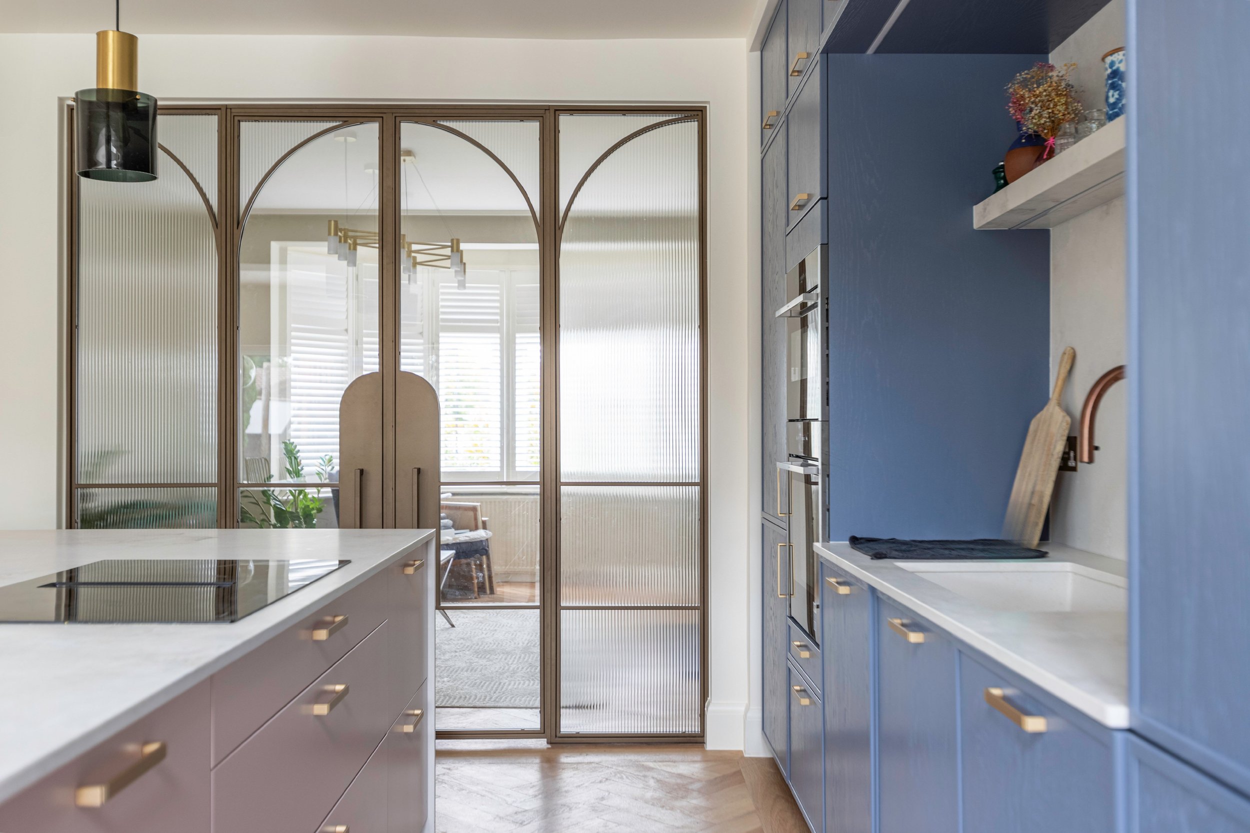 Mixed clear and reeded glass steel double doors with arched bars in Winchmore Hill