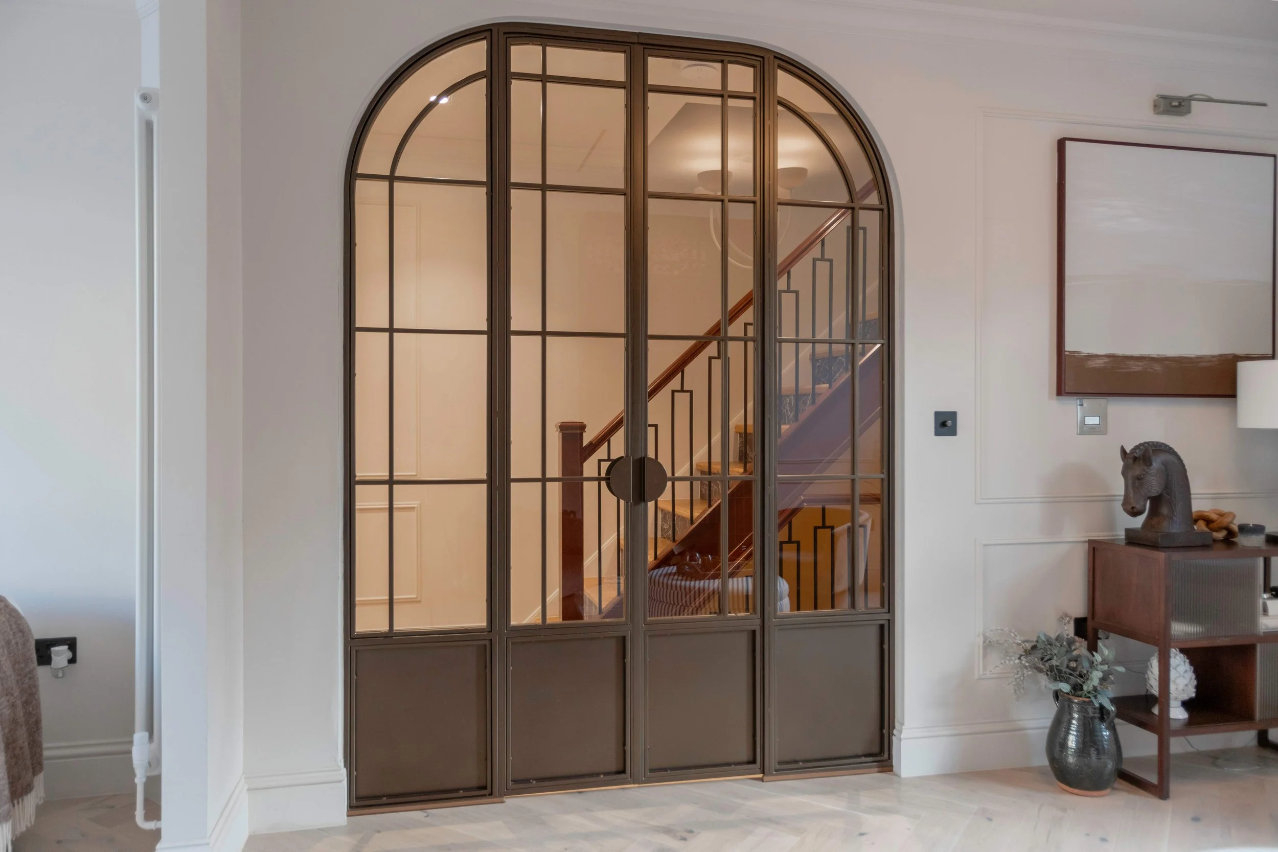 bespoke-bronze-arched-steel-double-door-set-hallway.jpeg