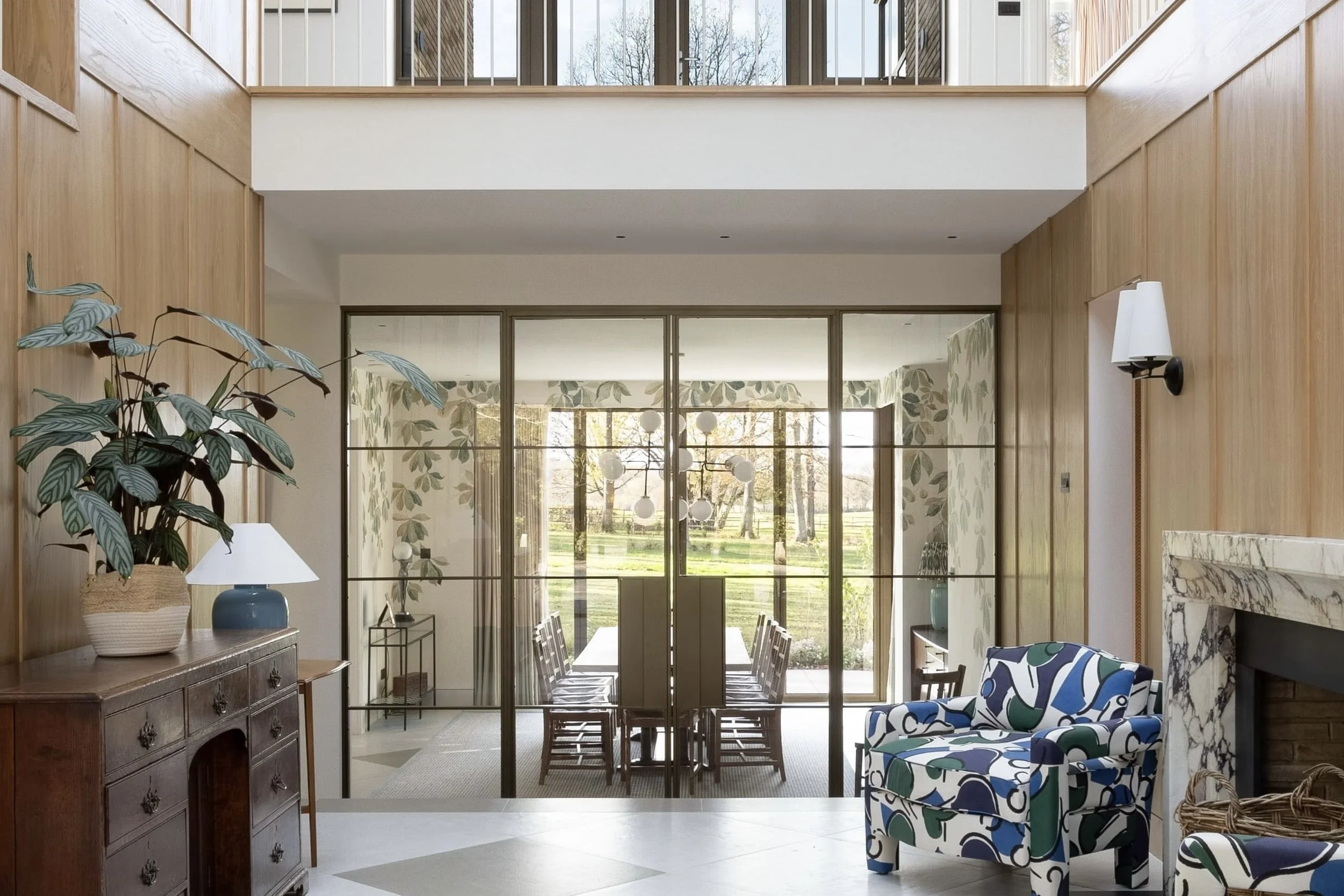 Double steel door set, finished in bronze, in a grand entrance hallway