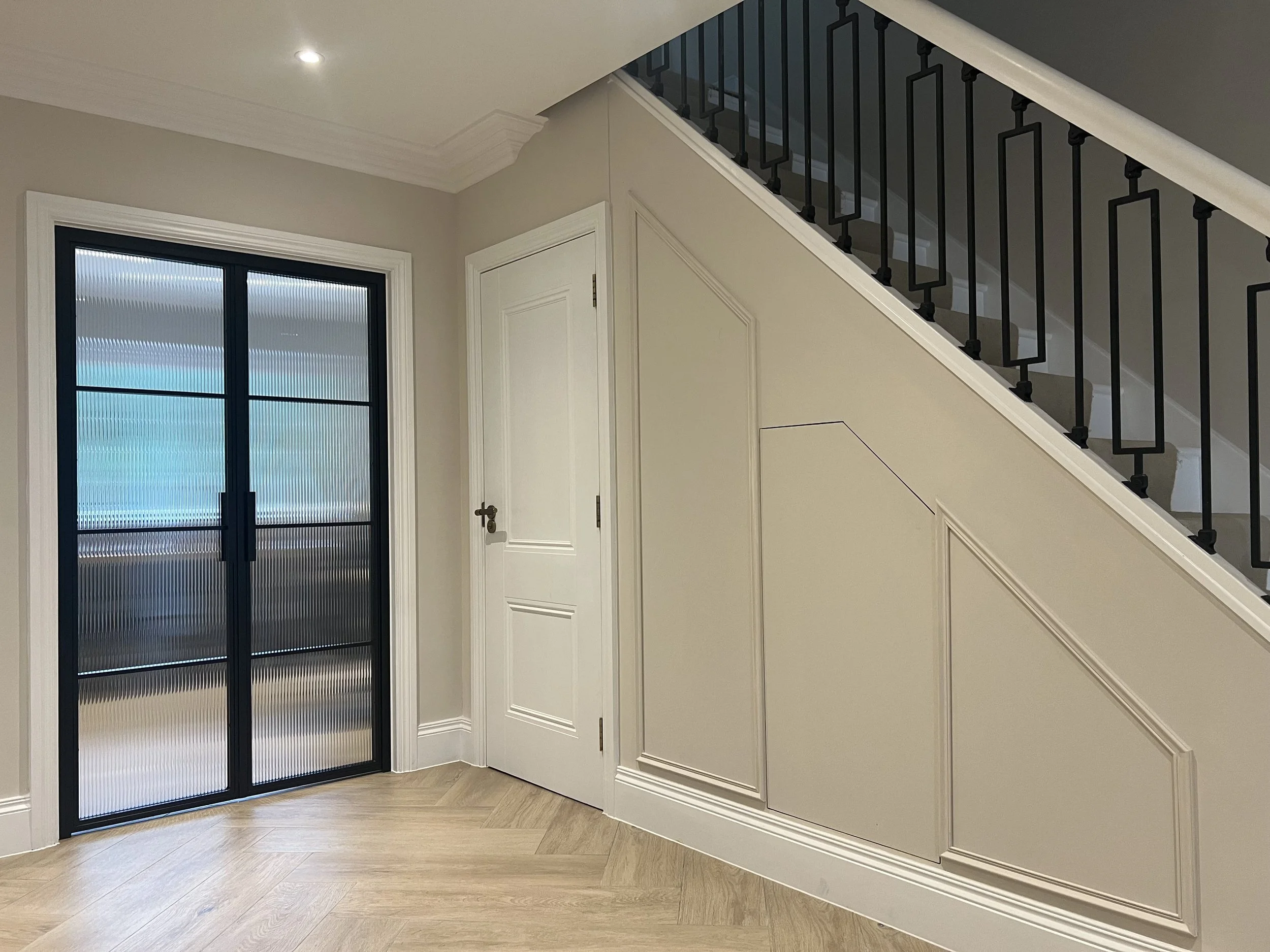 Steel framed door with reeded glass providing privacy while allowing light through