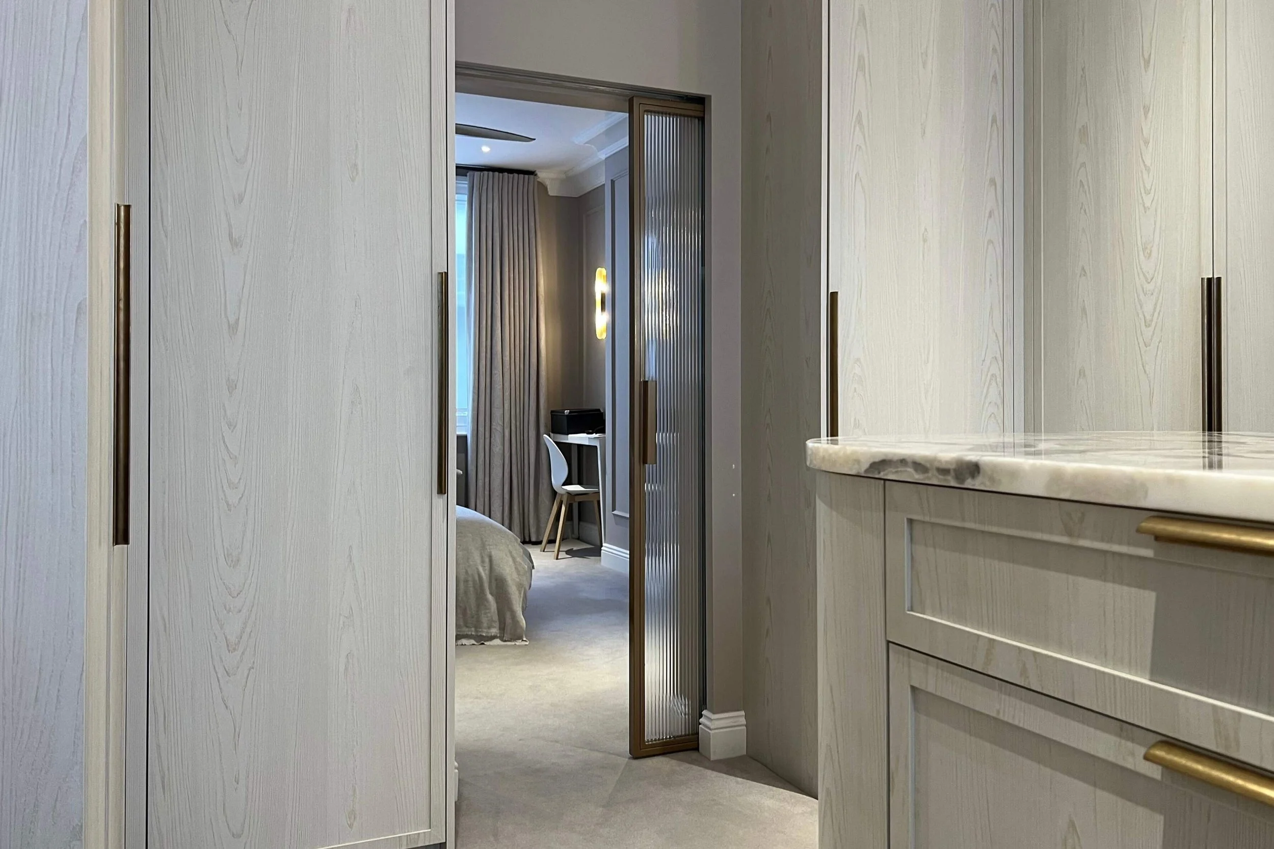 Steel pocket sliding door between bedroom and dressing room in a luxury home