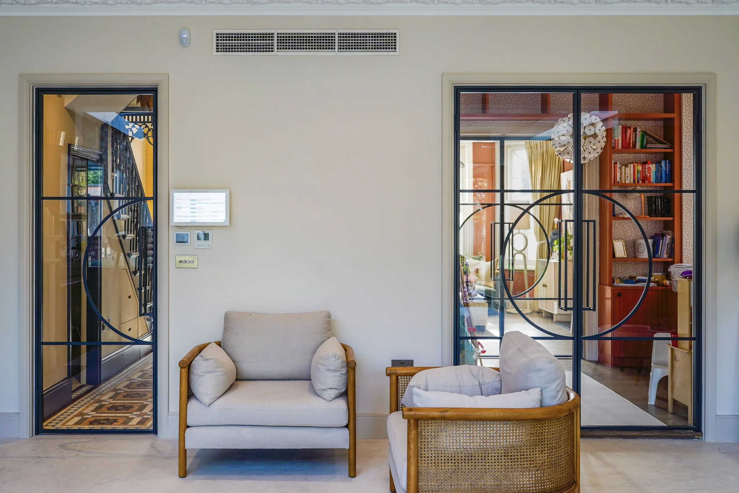 Bespoke steel internal screen dividing an open plan ground floor into defined zones in a luxury home by Joshua James.