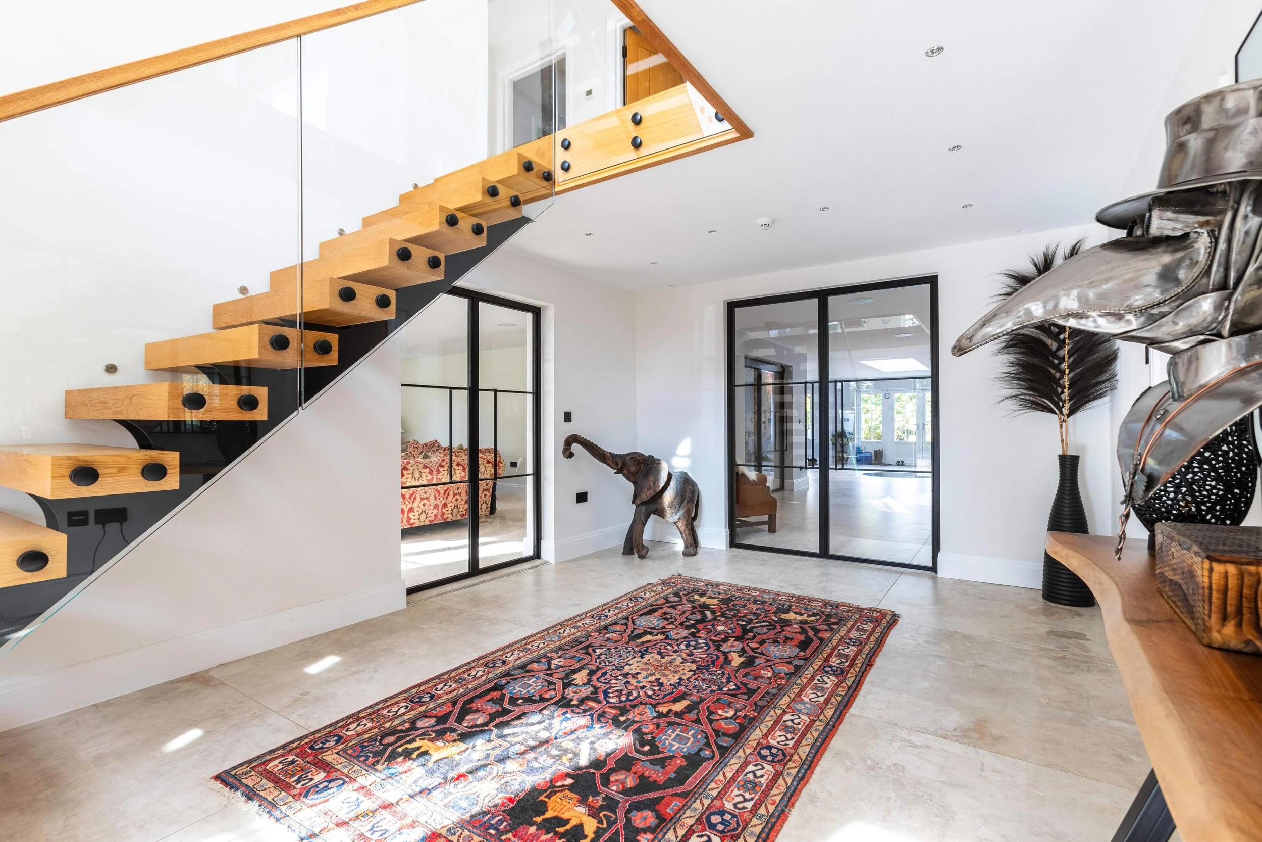 Steel framed doors with clear glass allowing natural light between rooms in a luxury home