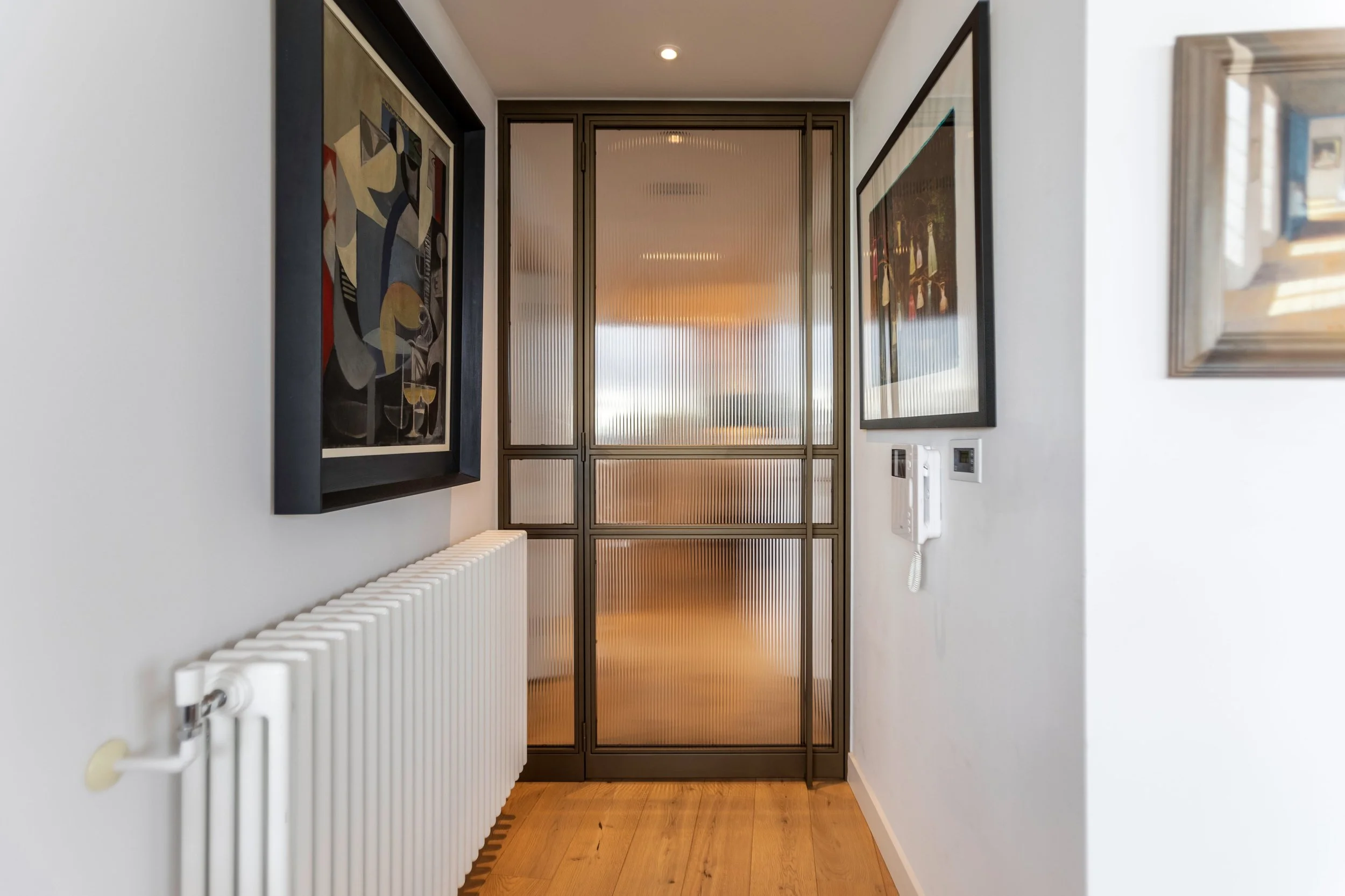 Bronze-finished steel internal doors acting as a focal point between living and hallway