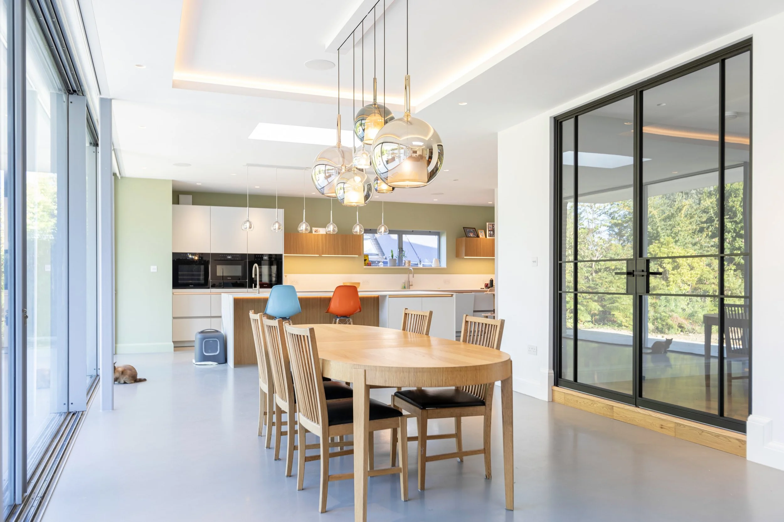Fire rated steel door providing separation between kitchen and hallway in a luxury residential interior