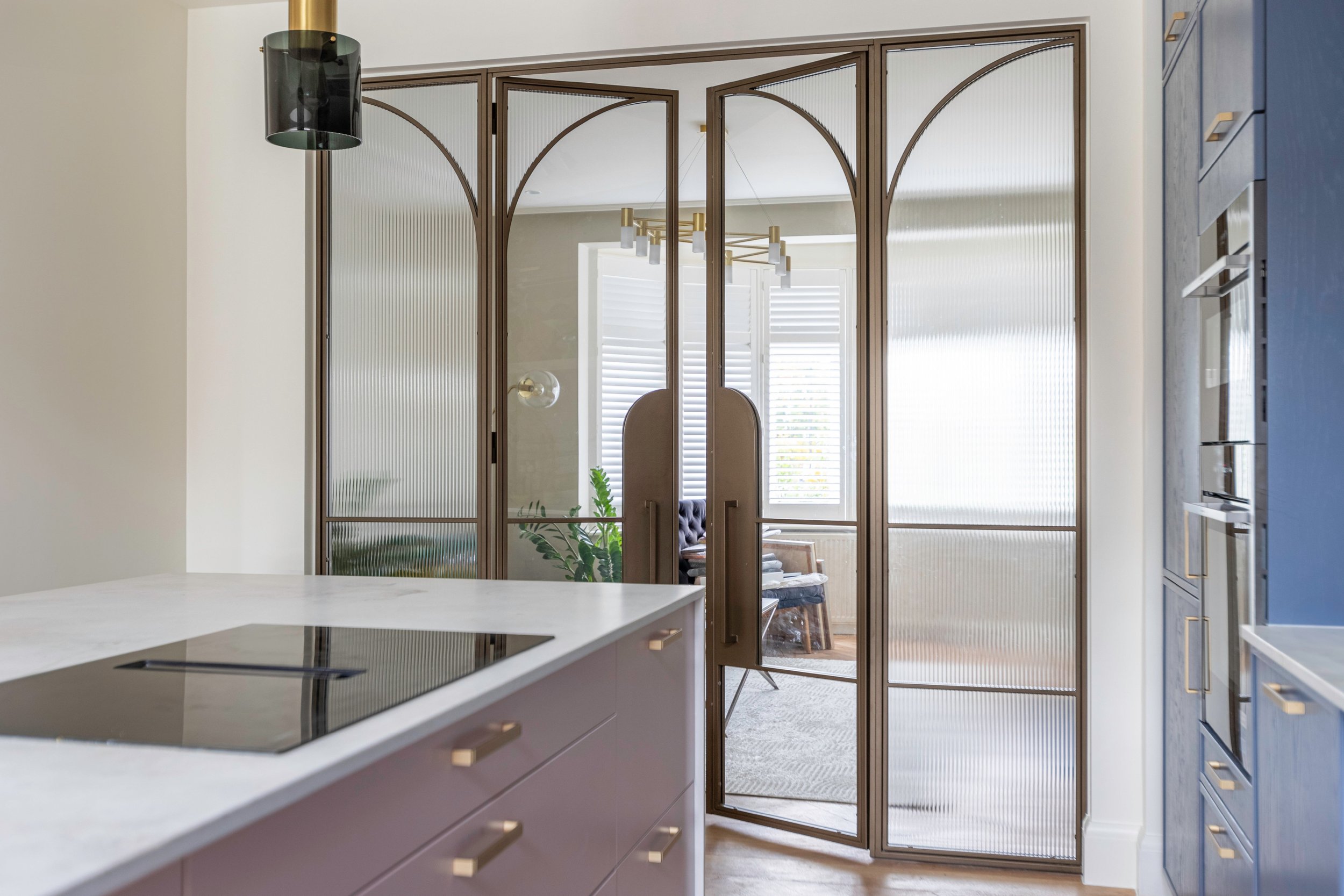 Steel internal door combining clear and reeded glass panels for a contemporary layered aesthetic