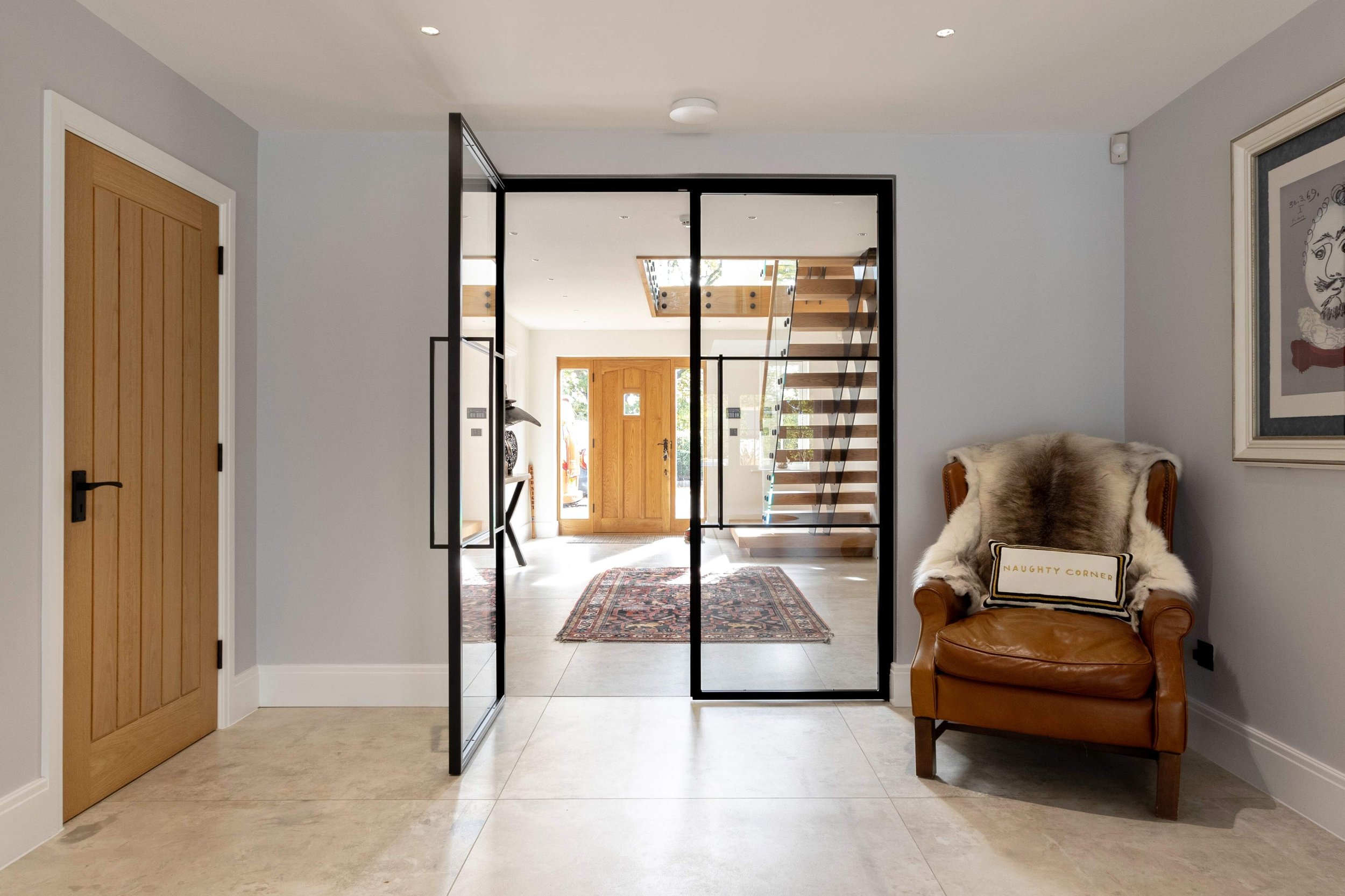 Black steel double doors enhancing flow and architectural design within a luxury home