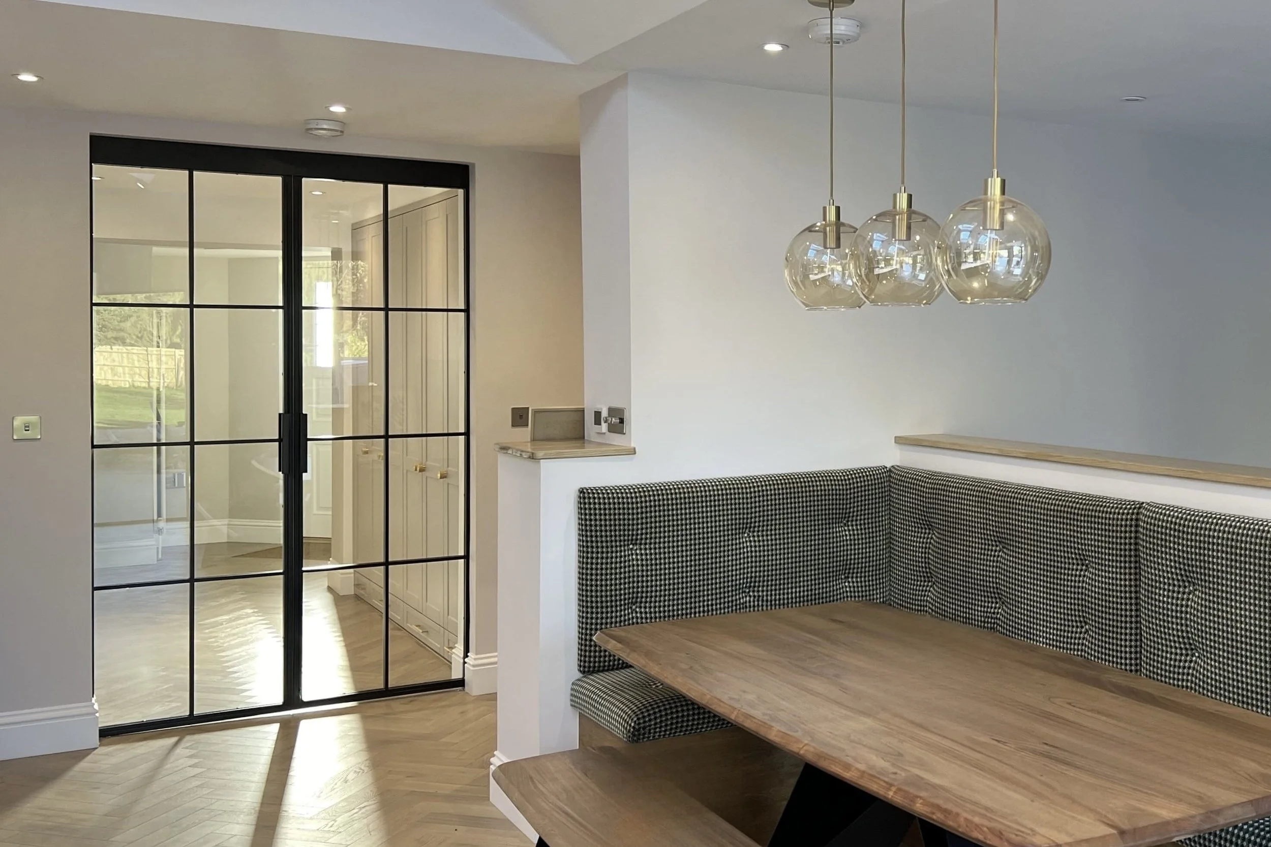 Bespoke steel pocket sliding door disappearing into wall cavity in a luxury home by Joshua James.