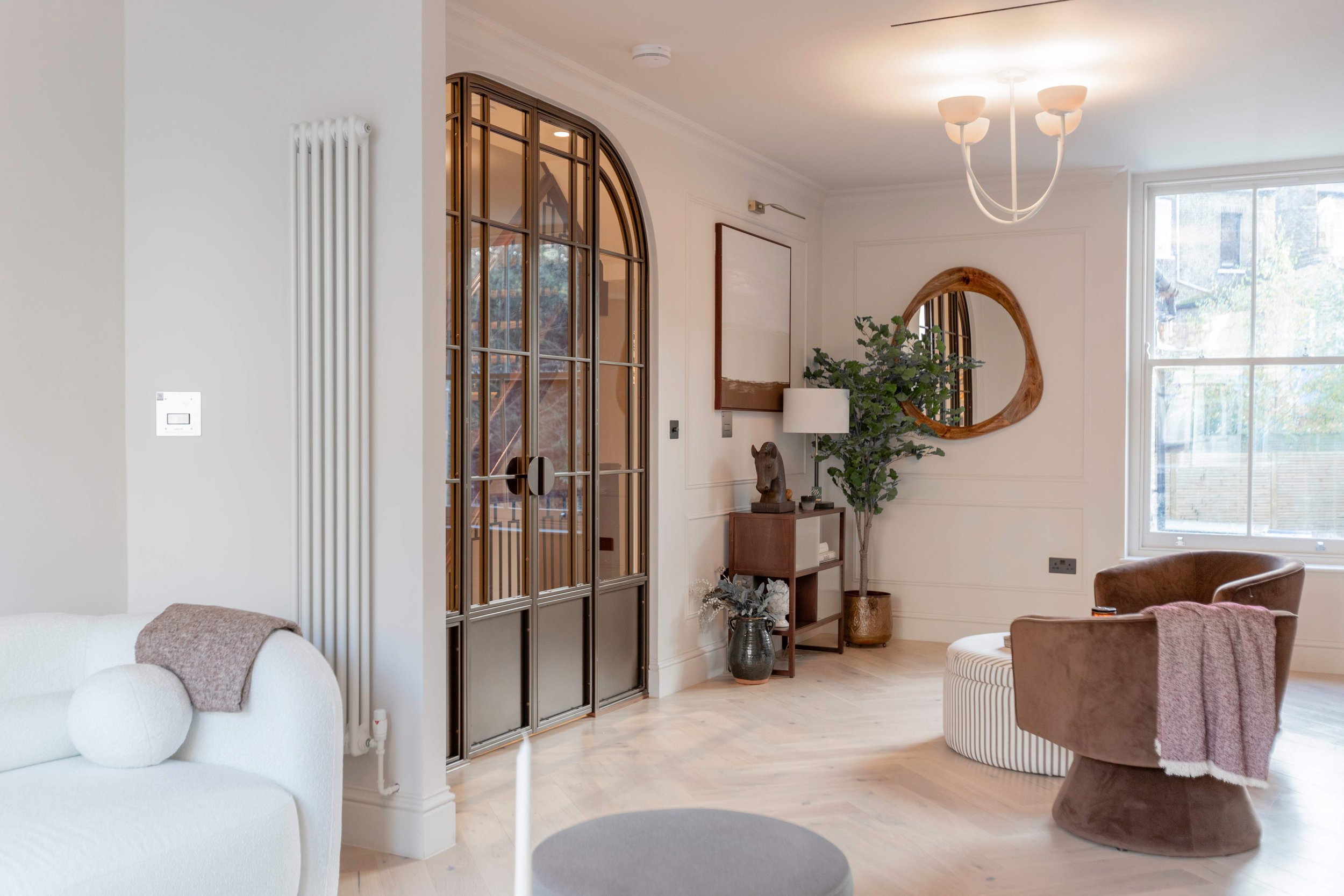 Bronze arched steel doors in Hackney with curved handles and kick plates