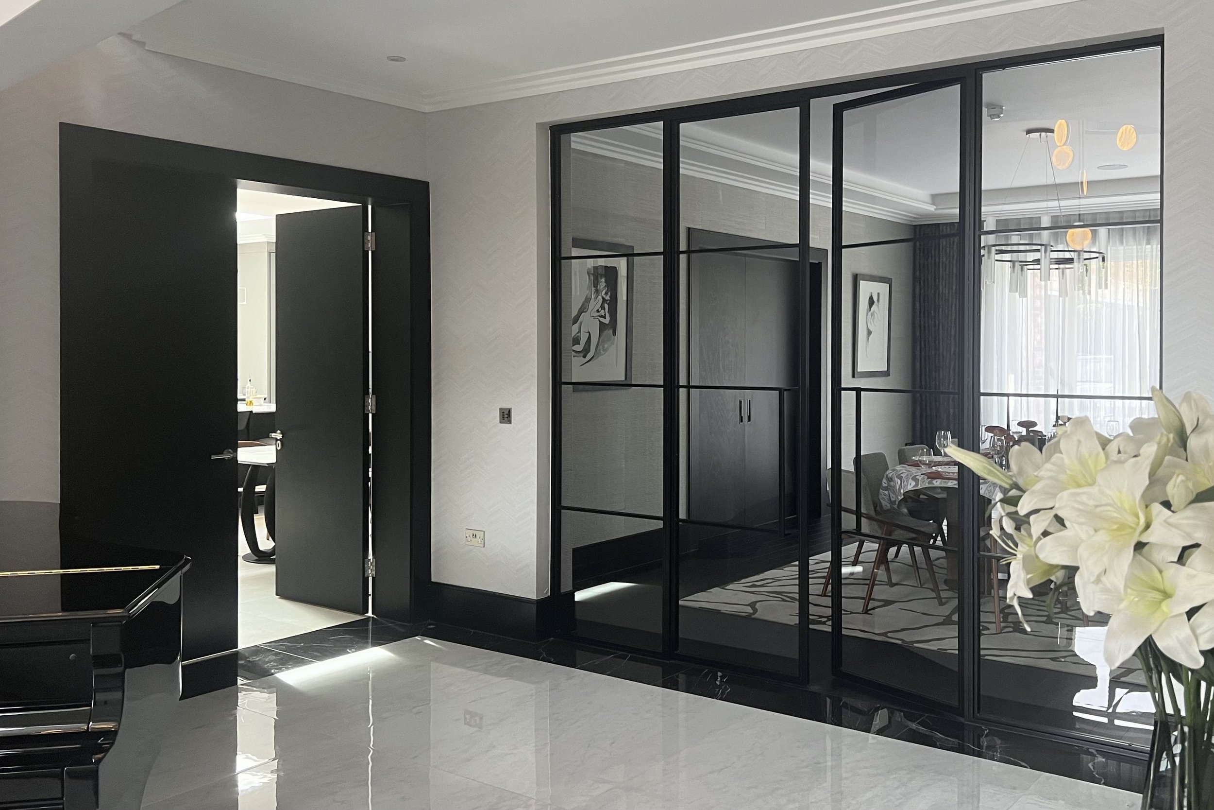 Jet Black steel internal doors dividing hallway and dining area in a luxury Neo-Georgian home