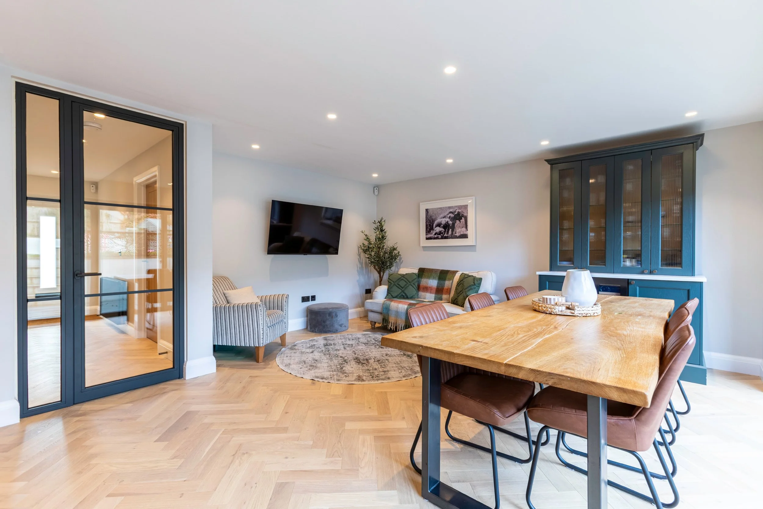 Single fire rated steel door with fixed screen bringing light into a hallway in Earlswood Surrey.