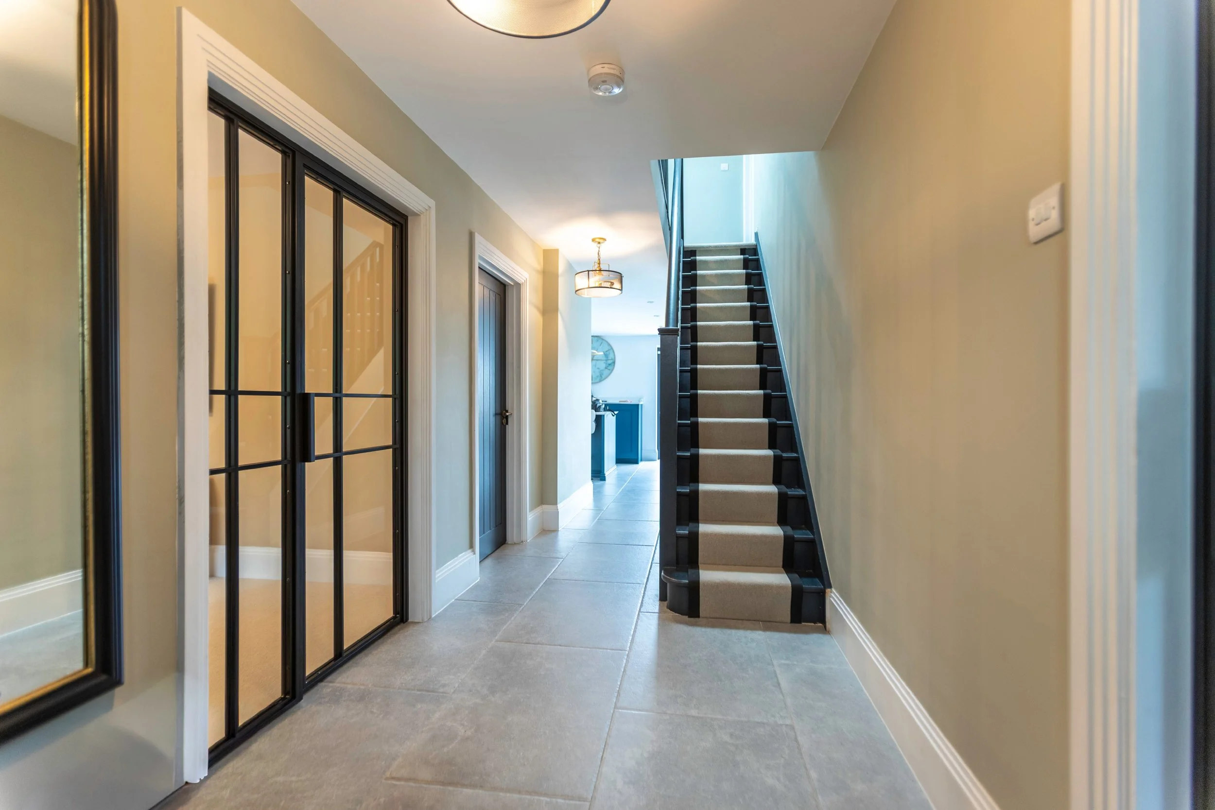 Single steel internal door with fixed side screen in a hallway setting maintaining light flow by Joshua James.