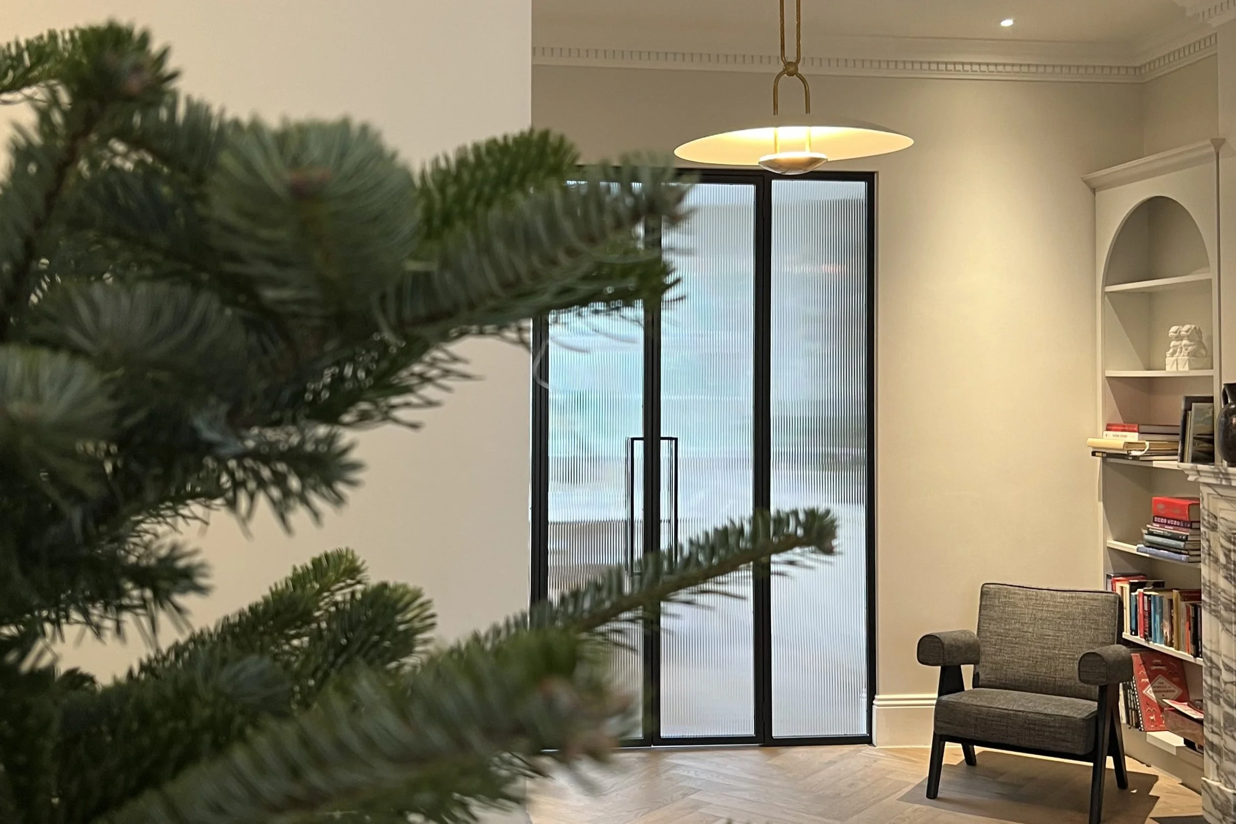 Steel internal room divider keeping warmth in a winter living room