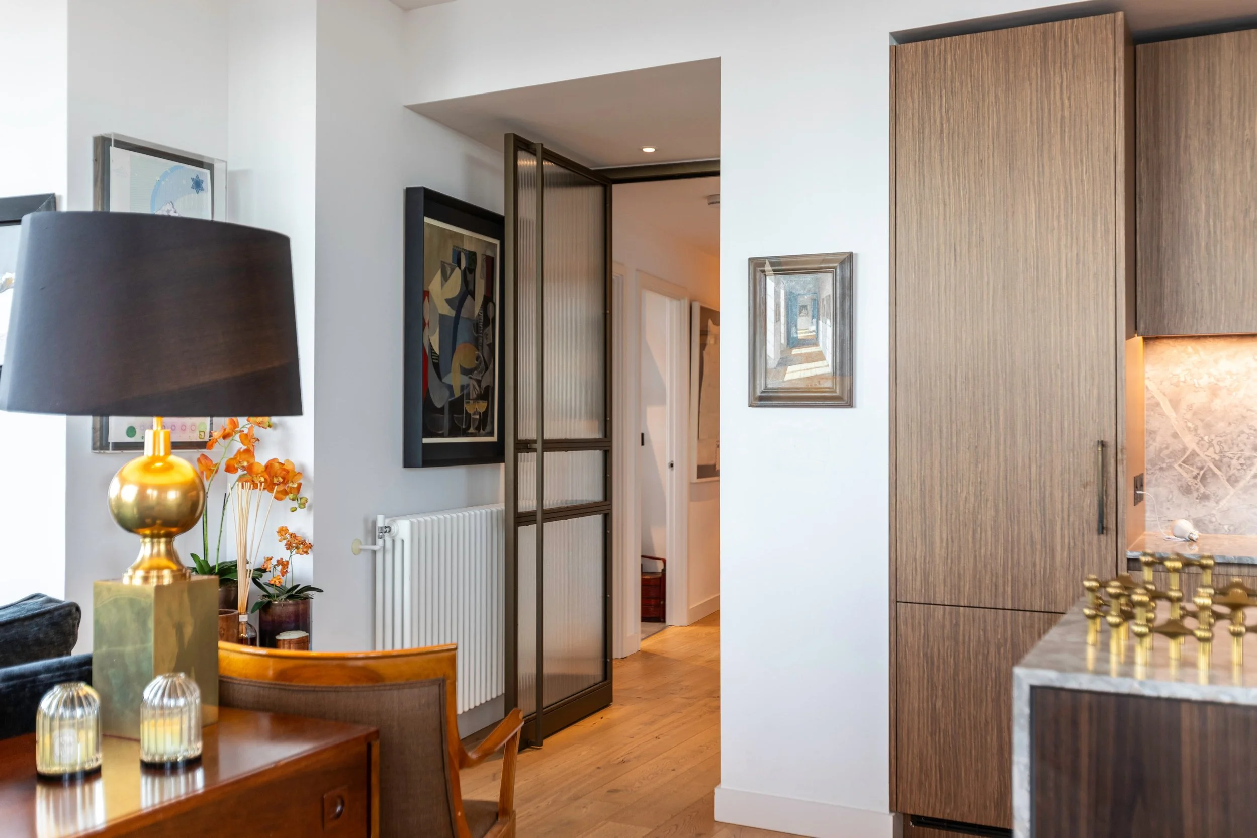 Well designed bronze steel door, folding back onto radiator