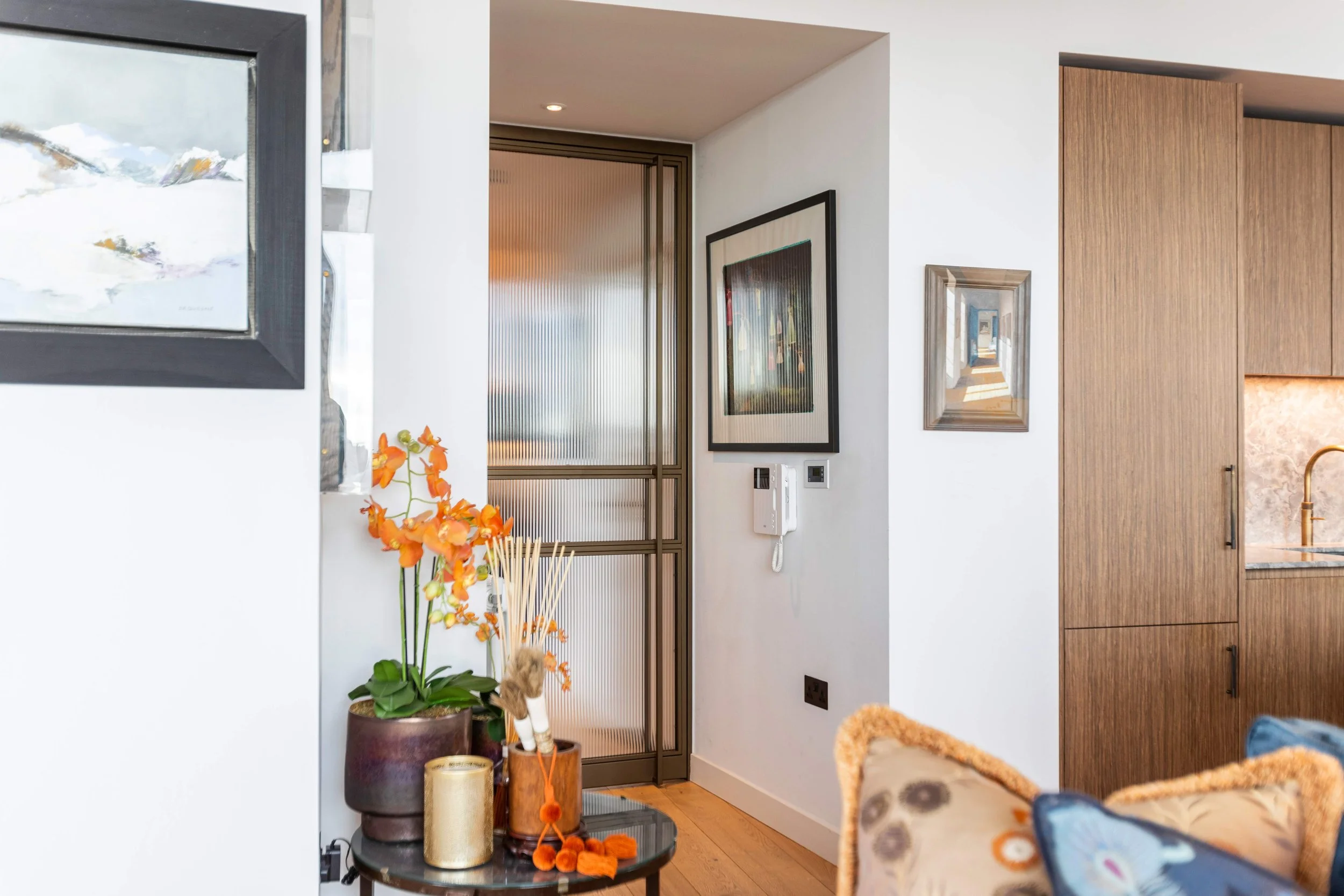 Bronze-finished double steel doors adding warmth to an elegant modern interior