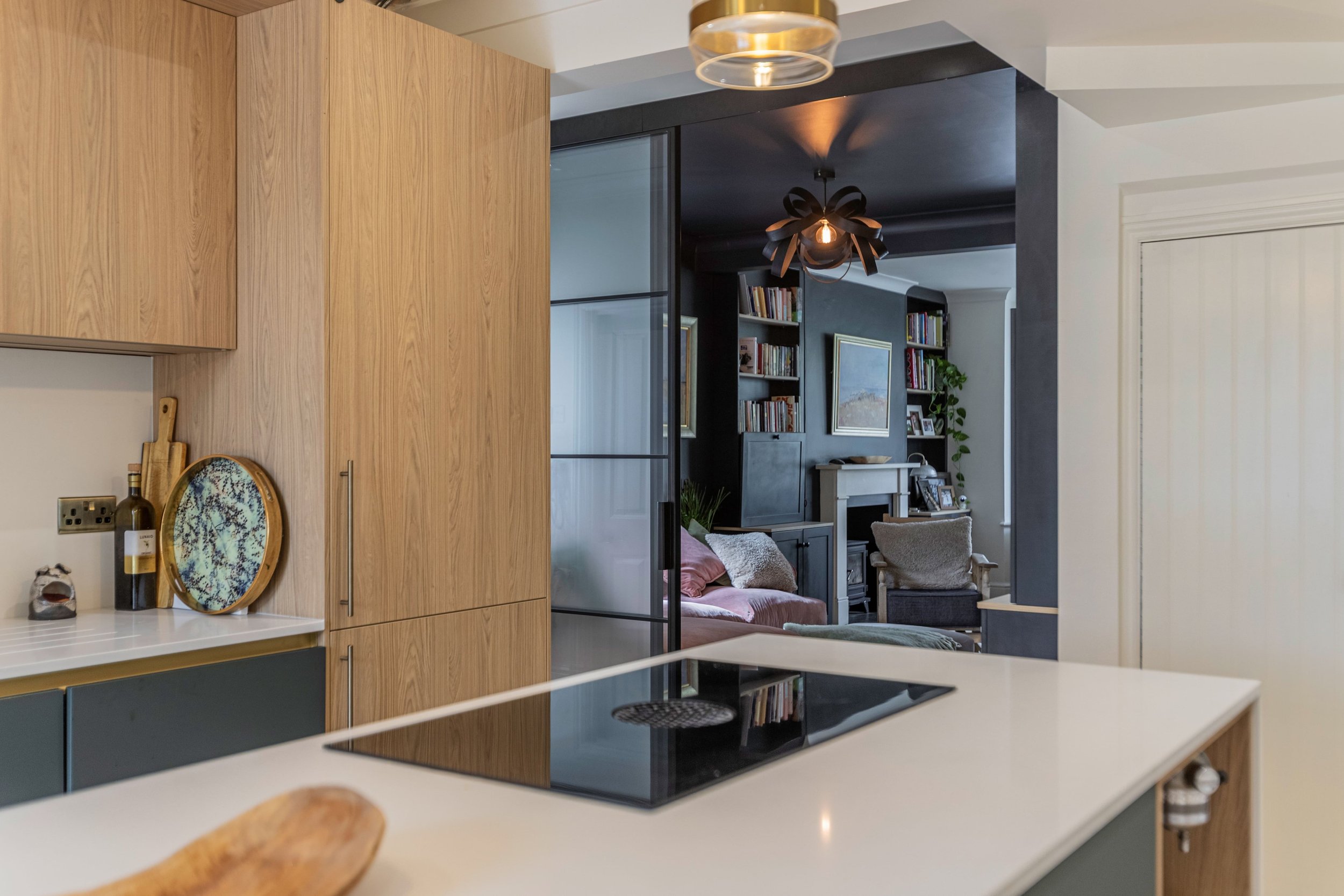 Sliding steel doors dividing kitchen and living spaces in a luxury open plan interior