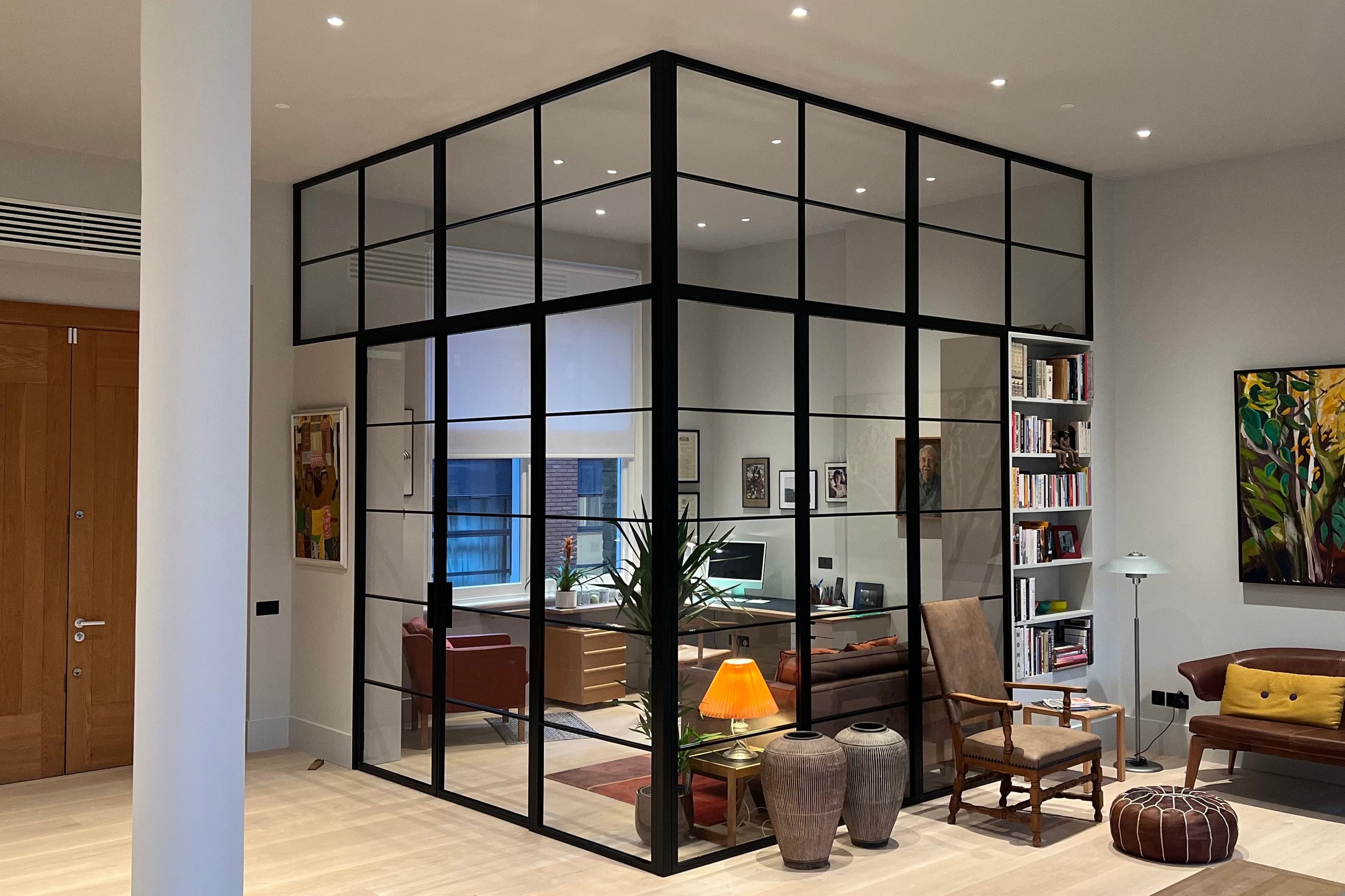 Bespoke L-shaped steel internal screen with double door set dividing an open plan living space by Joshua James.