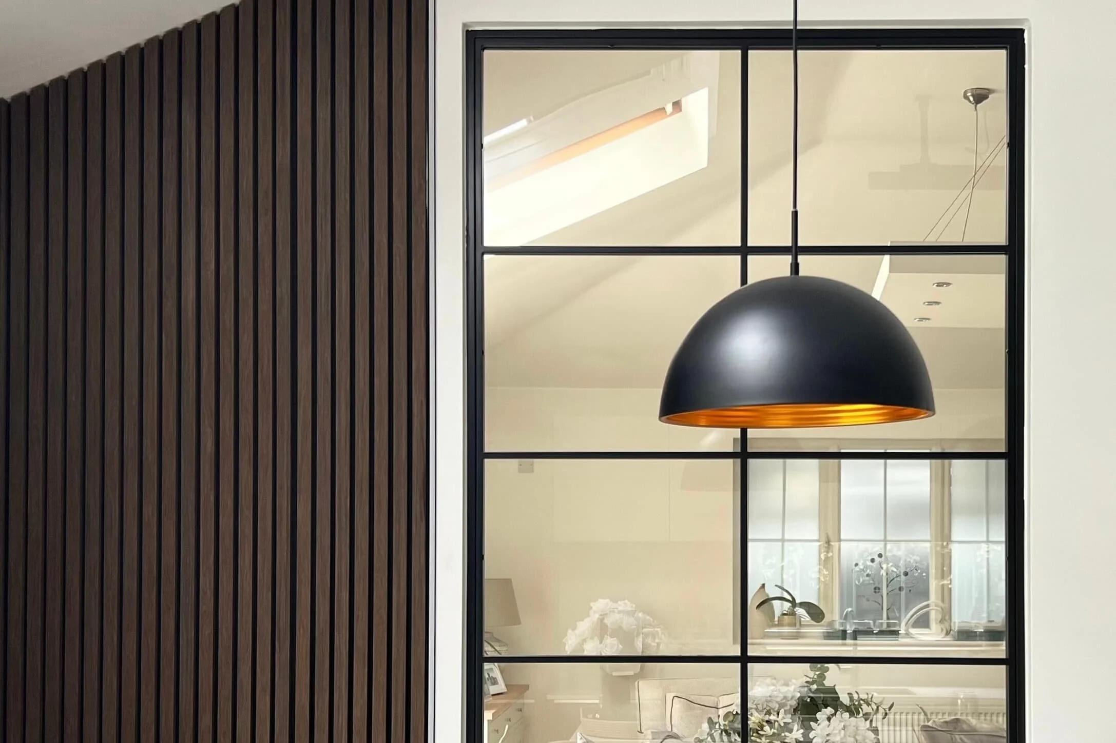 Close-up detail of bar layout and glass on a bespoke steel internal room divider by Joshua James.