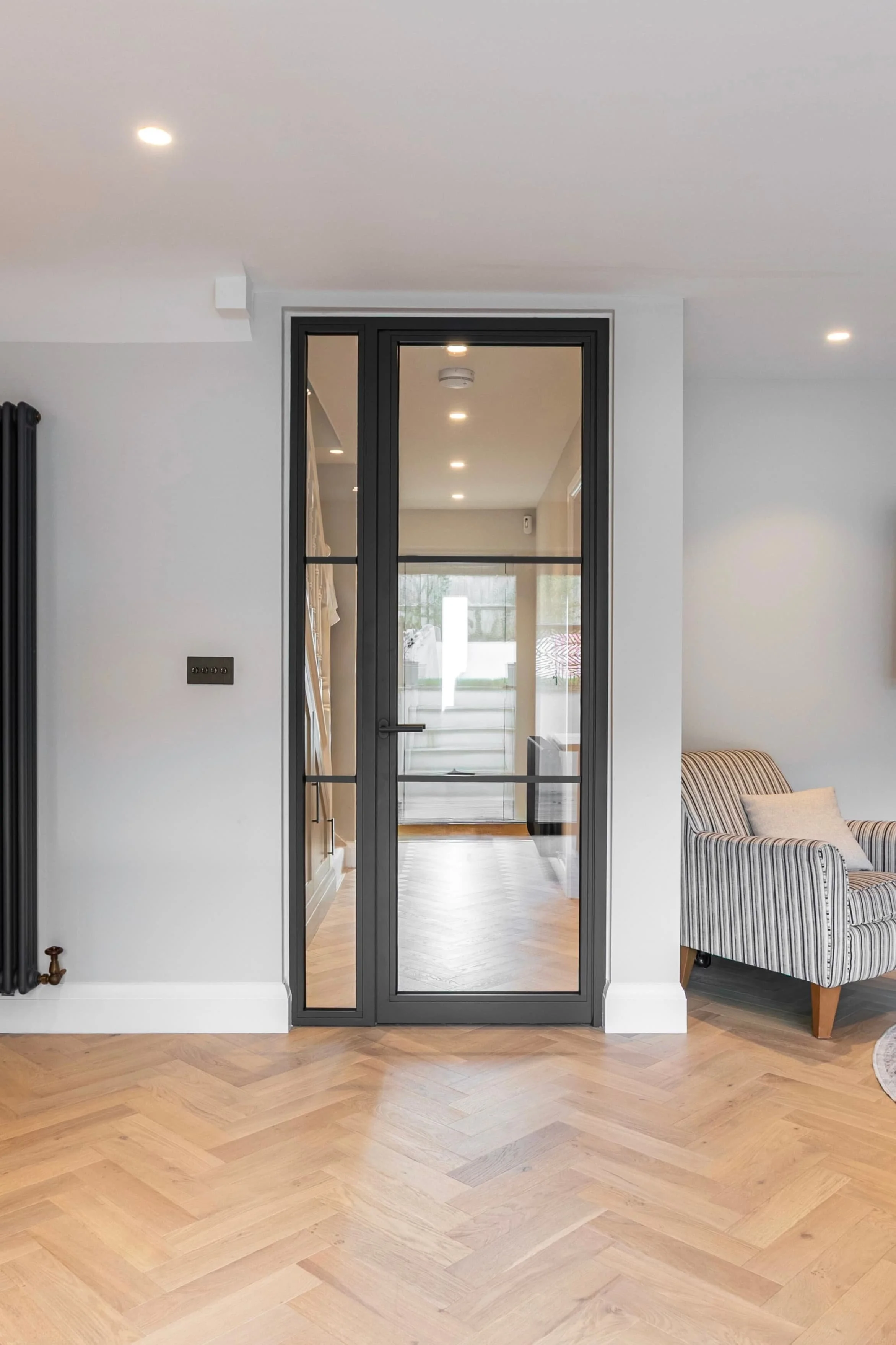 Steel framed fire rated single door with fixed screen between hallway and kitchen in a Surrey home.