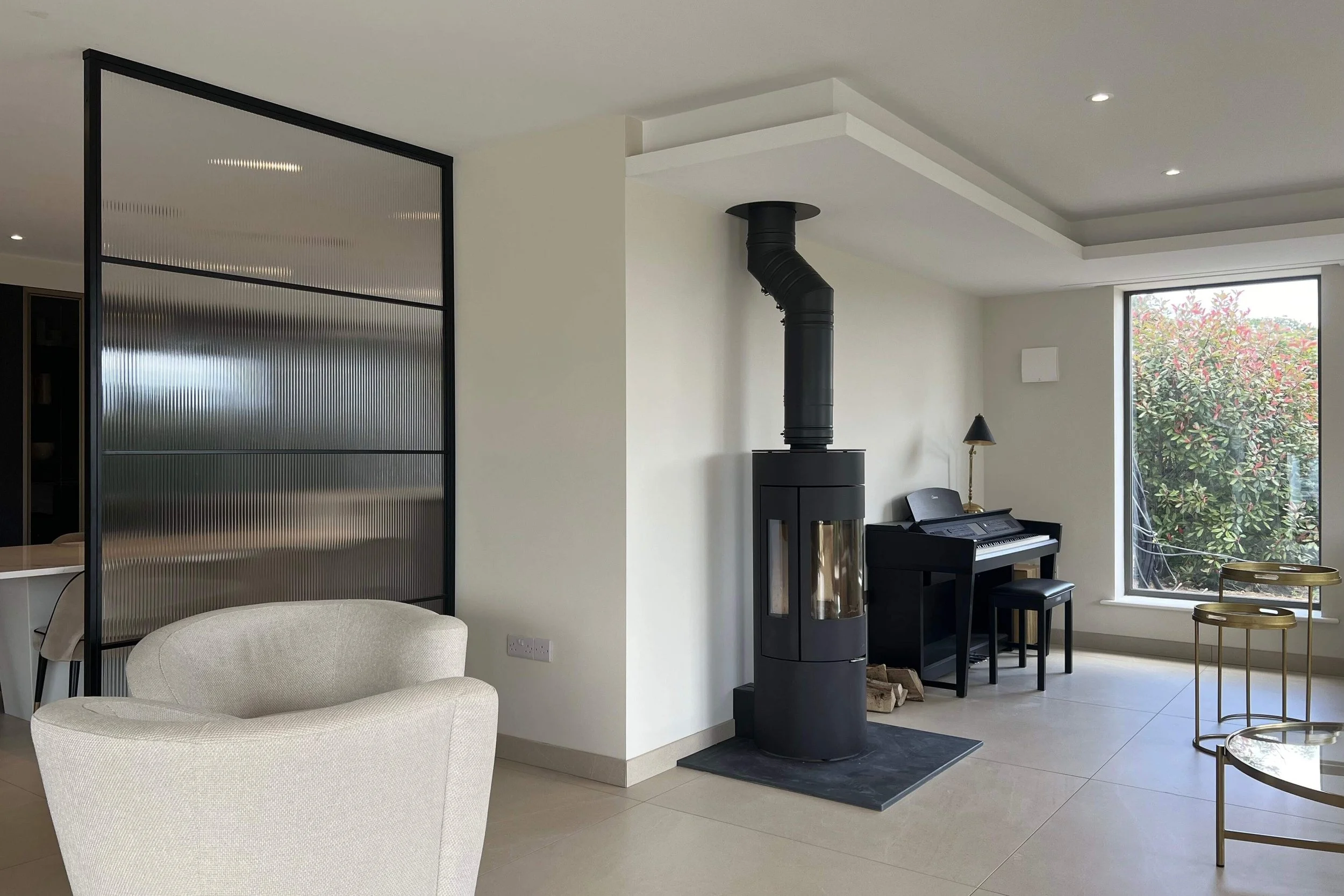 Steel framed partition dividing kitchen and living space in a luxury home