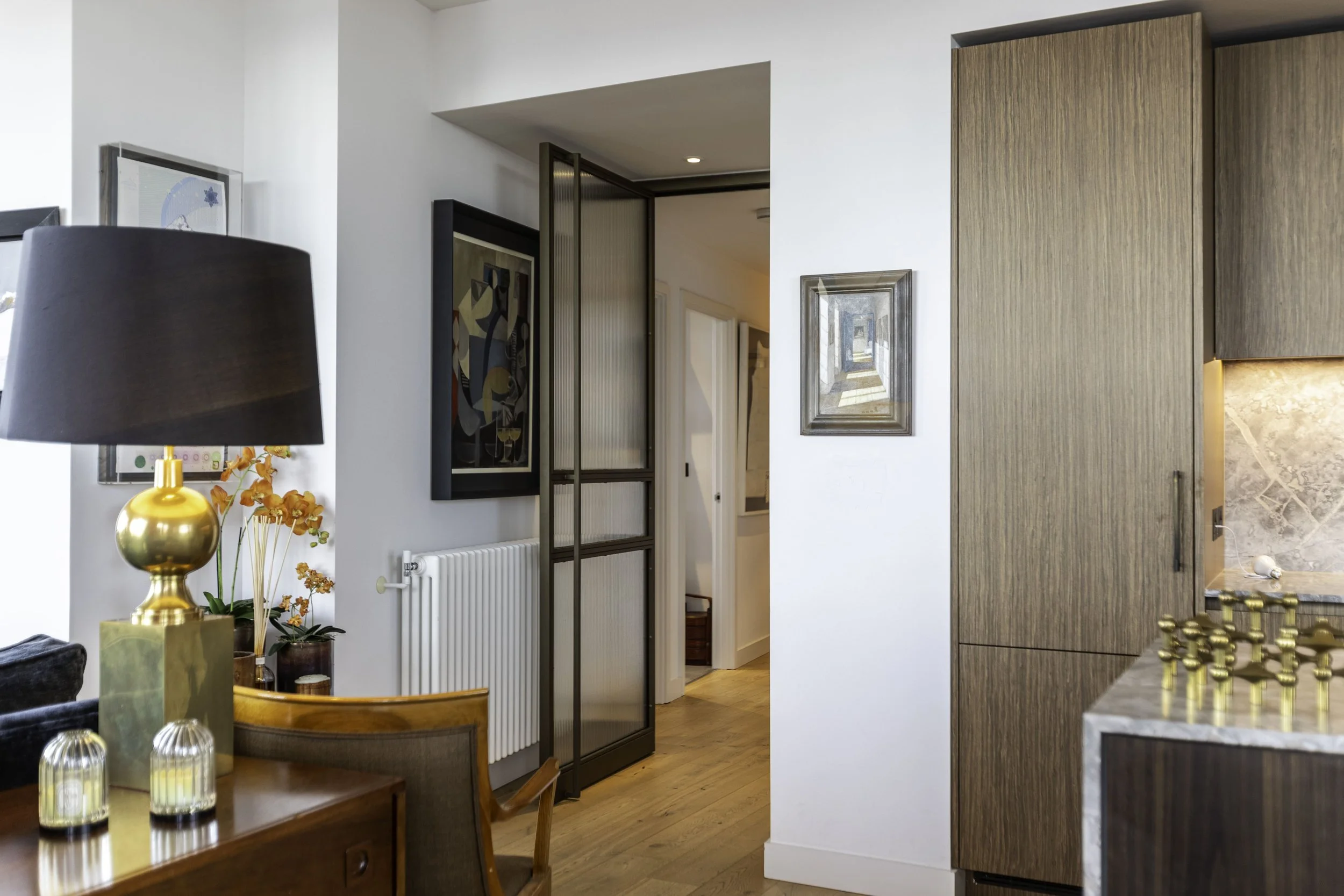 Well designed bronze steel door, folding back onto radiator