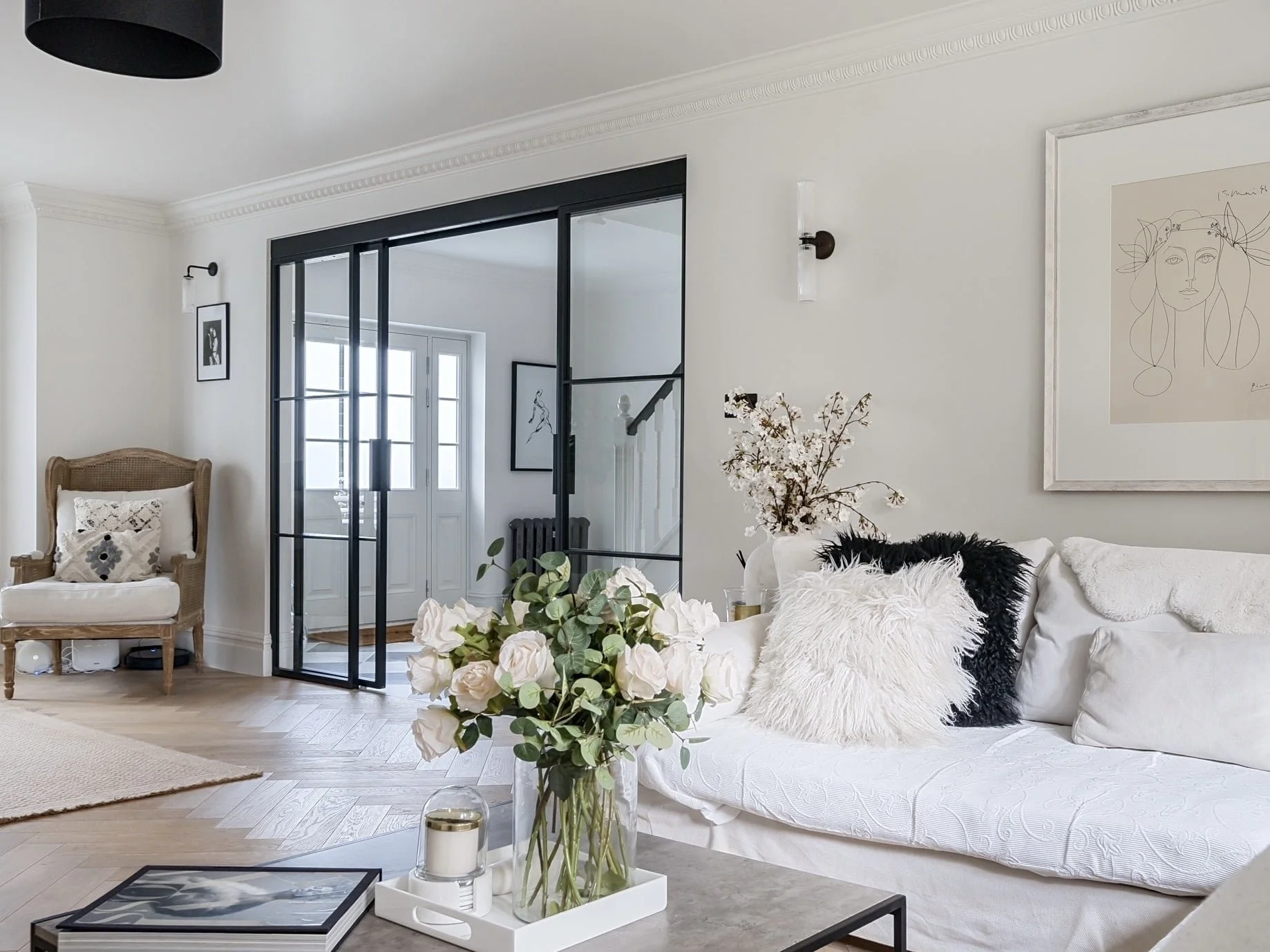 Sliding steel partition dividing living and entrance hallway in a luxury interior