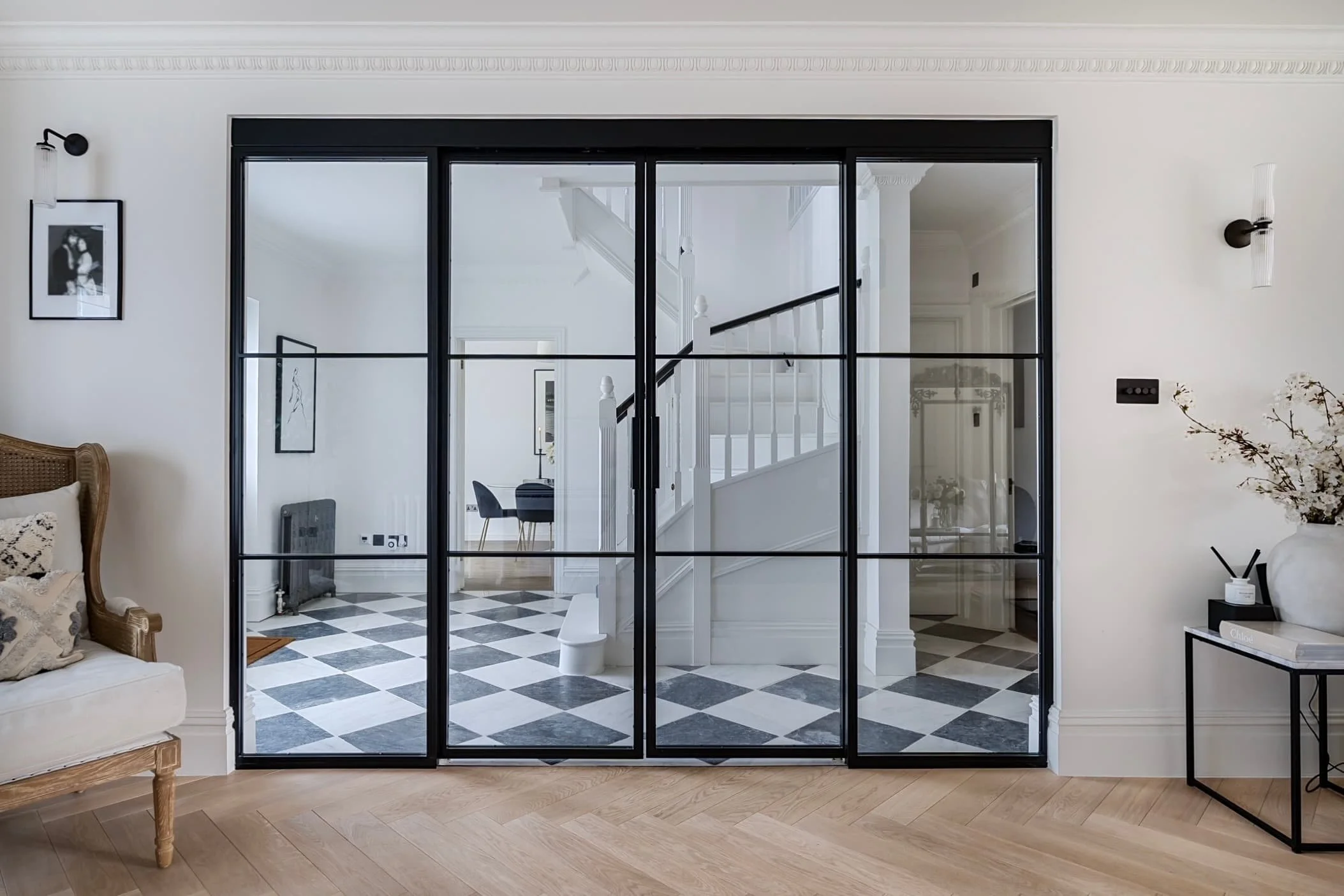 Double sliding steel internal doors with side screens creating a hallway division in an open plan home by Joshua James.