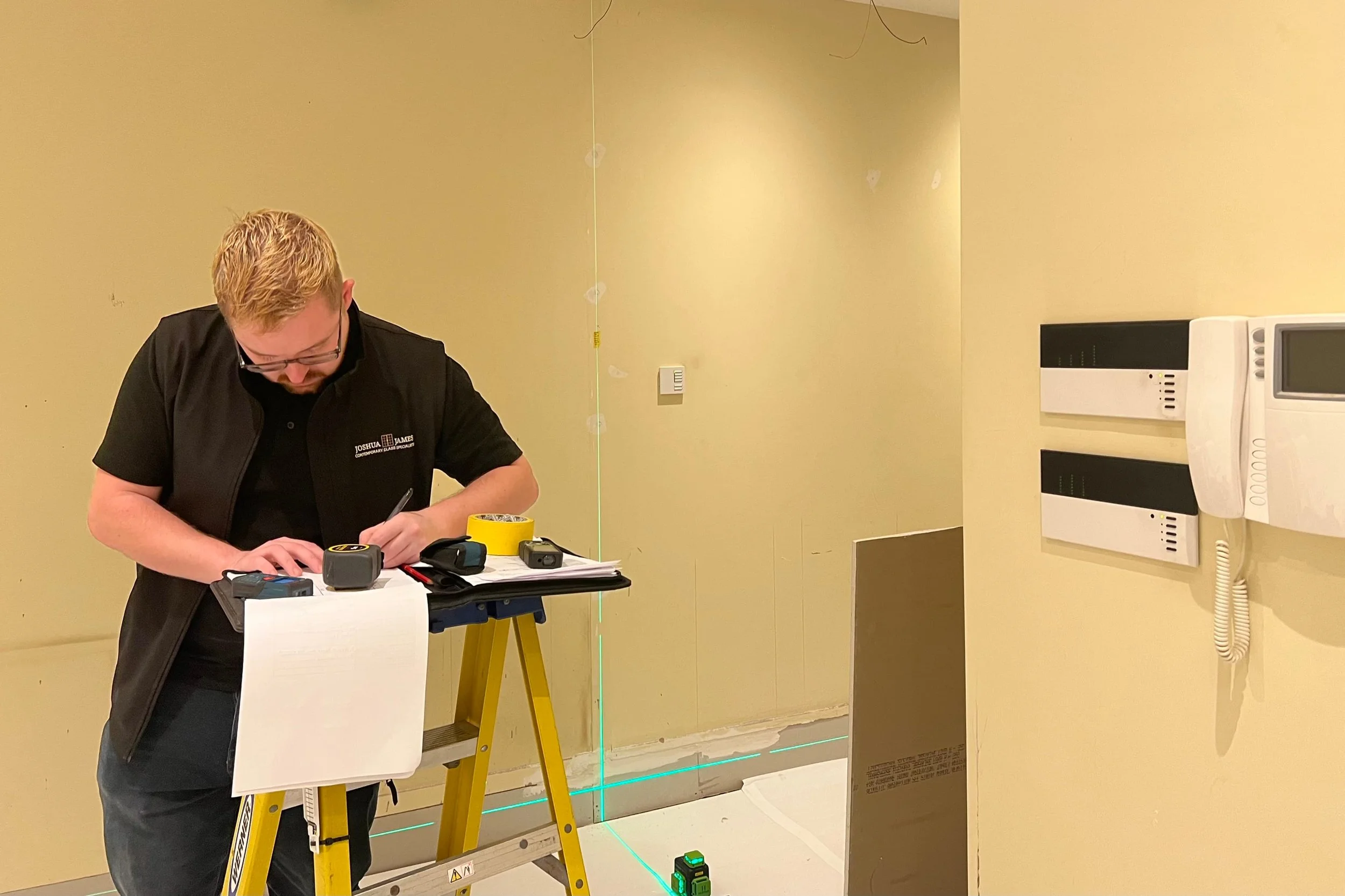 Joshua James team member surveying a door opening during the steel internal door installation process.