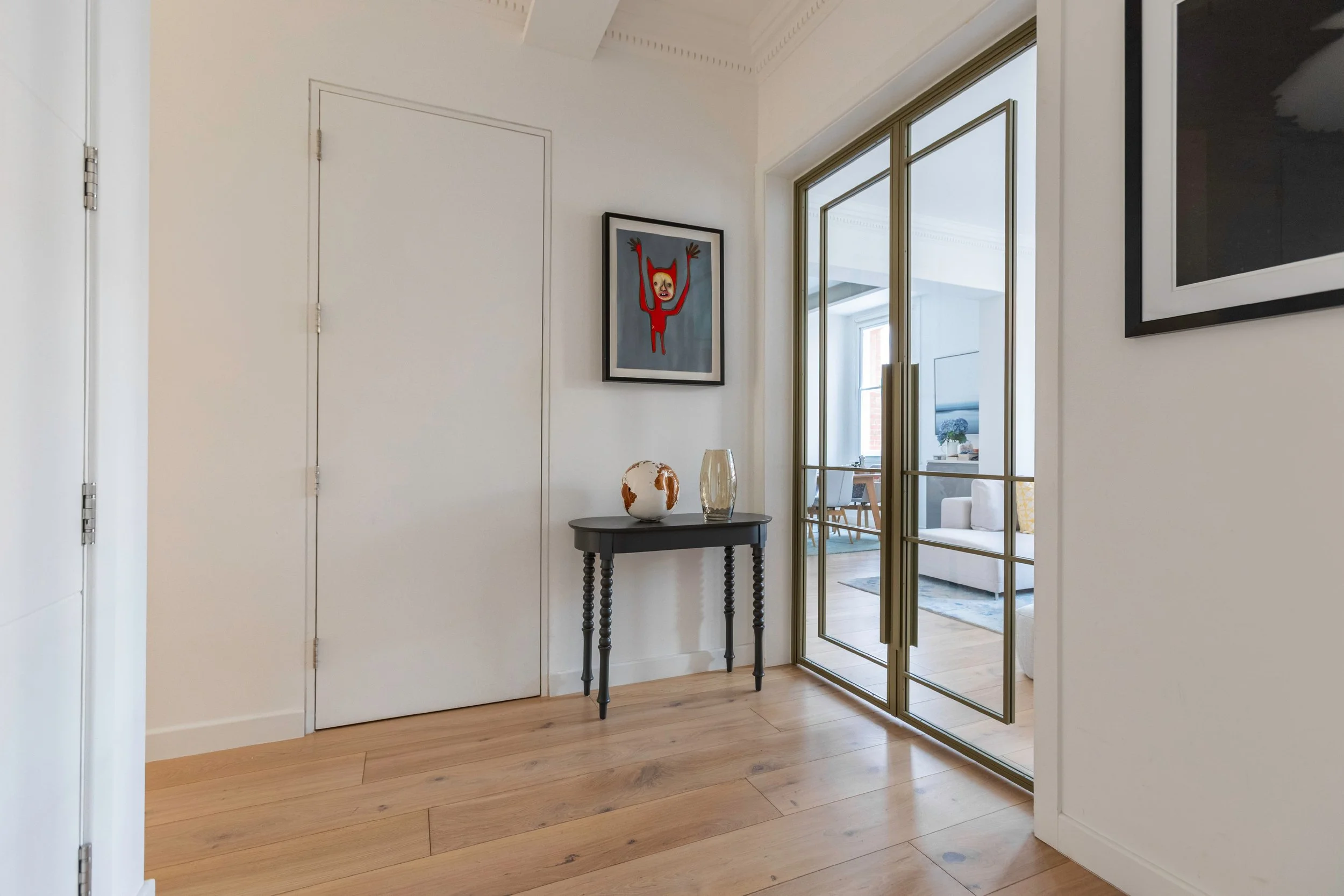 Olive grey double internal steel doors viewed from hallway with clear glass panels in Chelsea apartment.