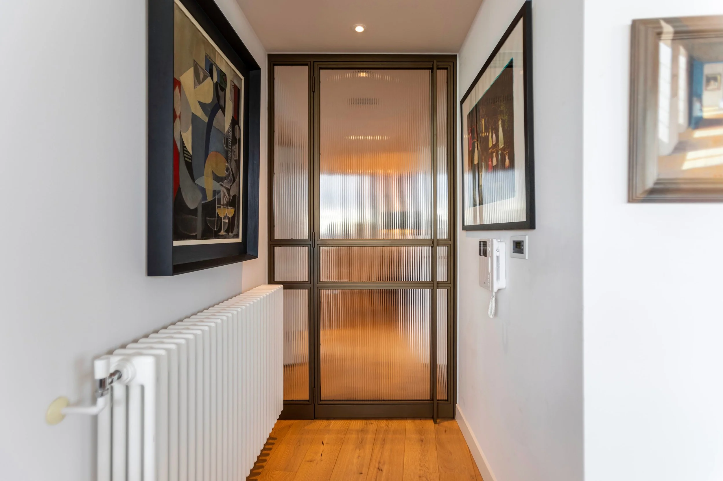 Bronze-finished steel internal doors acting as a focal point between living and hallway