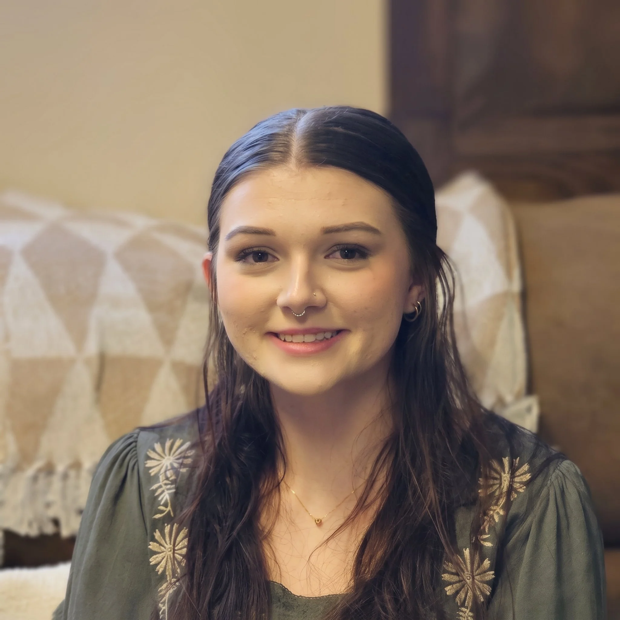 Headshot of Alexis Wilson, a Licensed Clinical Social Worker at Dandelion Therapy Group in North Port, Florida, wearing an embroidered dark green top.