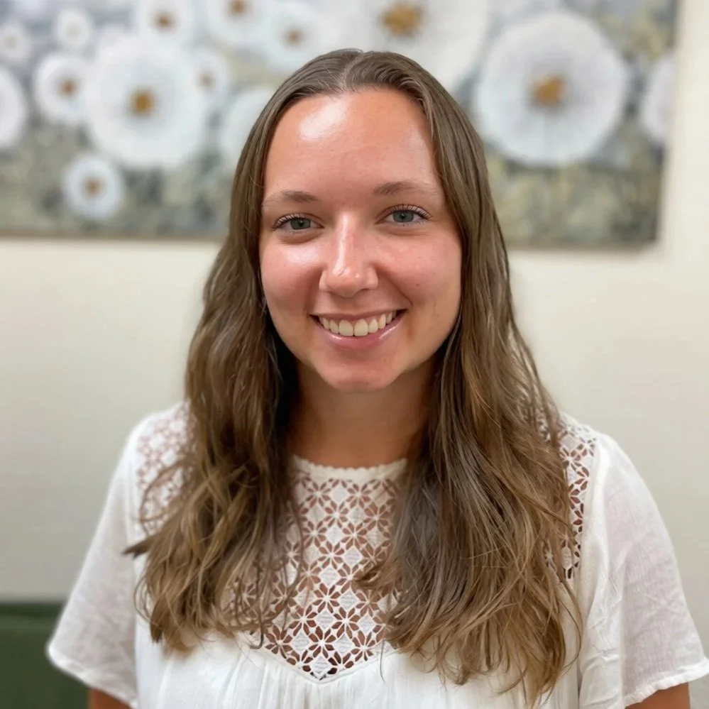 Dani Mills, therapist at Dandelion Therapy Group in Port Charlotte, smiling in a professional headshot against a neutral background.