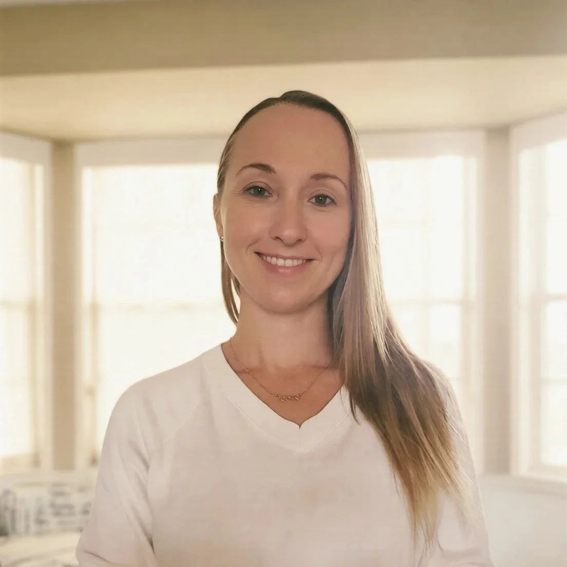 Lindsey Sipes, Administrative Assistant at Dandelion Therapy Group in Florida, smiling in a brightly lit room.