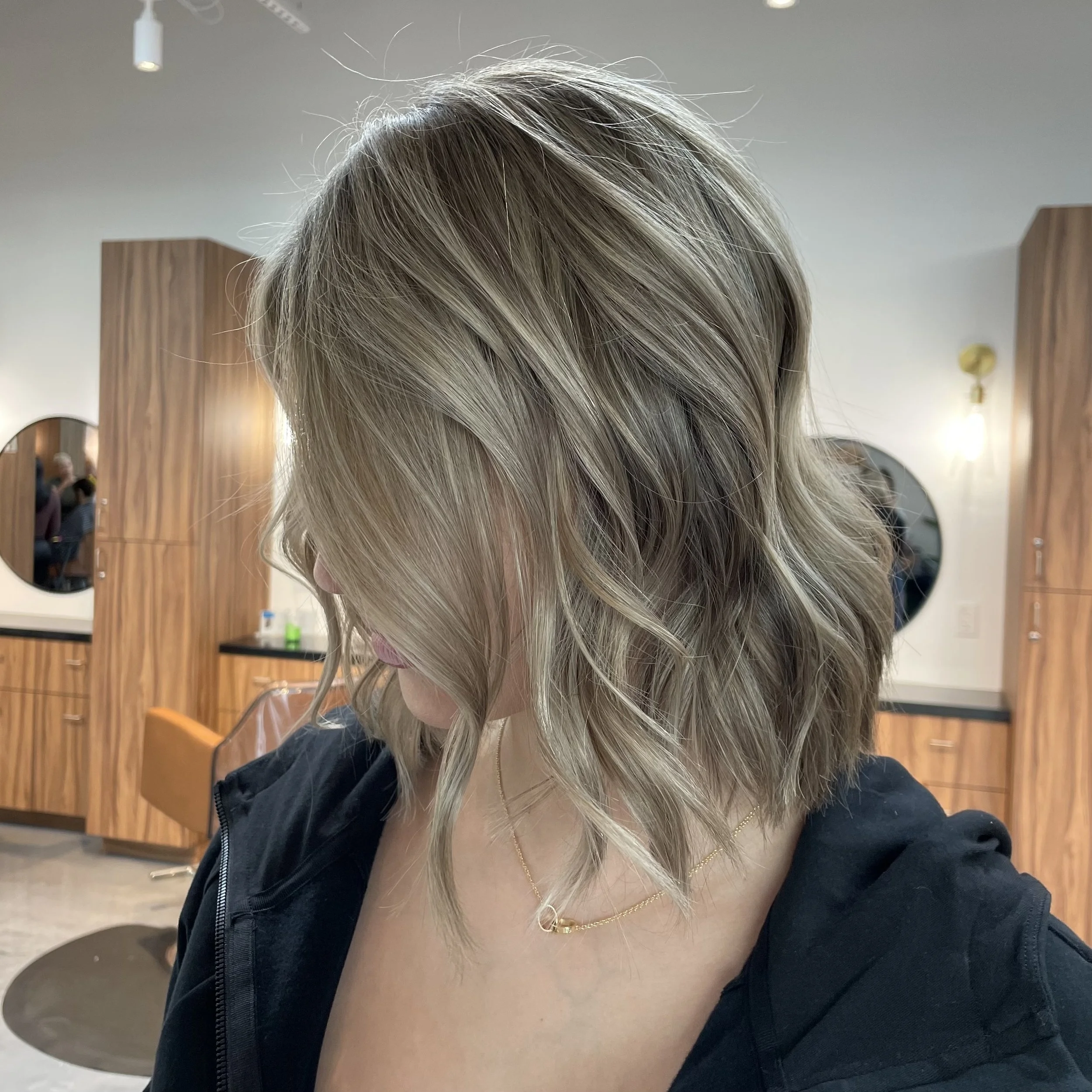 Blonde bob with soft waves and blended highlights, styled to showcase texture and movement, at EVOQ Salon in Las Vegas