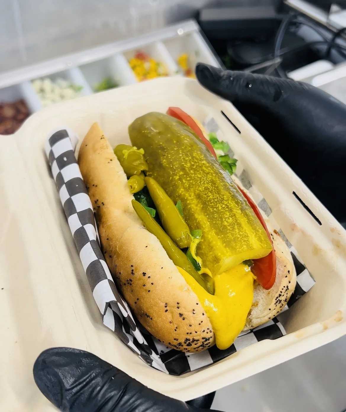 Hot dog topped with a pickle