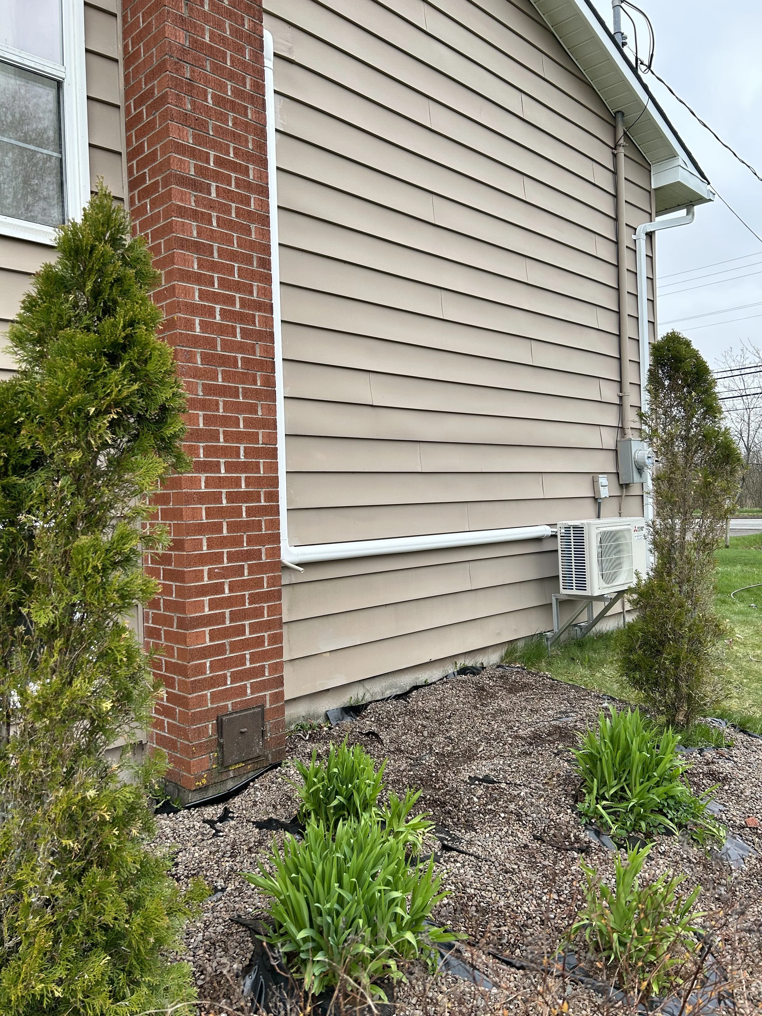 A House with an Installed Heat Pump -Outdoor Unit