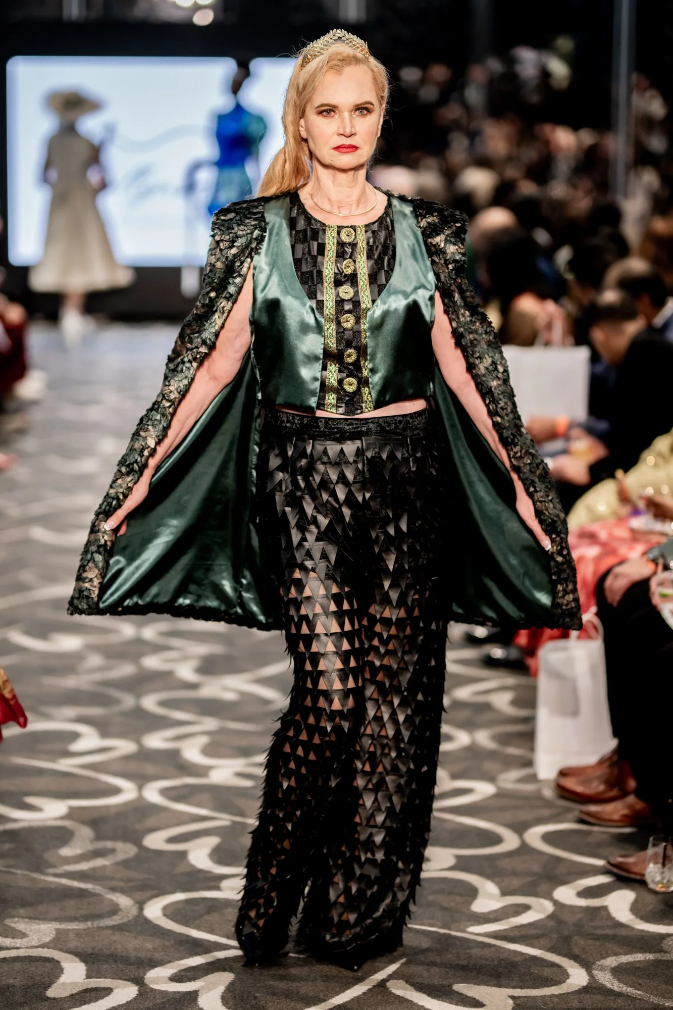 
Absolutely! Here’s a concise version in line with the TFF designer bios:
OLLYMACS by Olga Blake-McKenzie
OLLYMACS is an Australian label by Olga Blake-McKenzie, known for structured, symbolic designs that blend strength and softness. Each piece tell