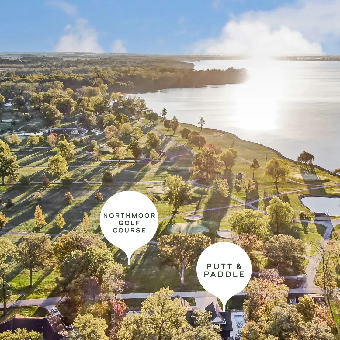 Aerial view of Northmoor Golf Course adjacent to a large body of water, with labeled areas for putting and paddling, surrounded by trees and residential buildings.