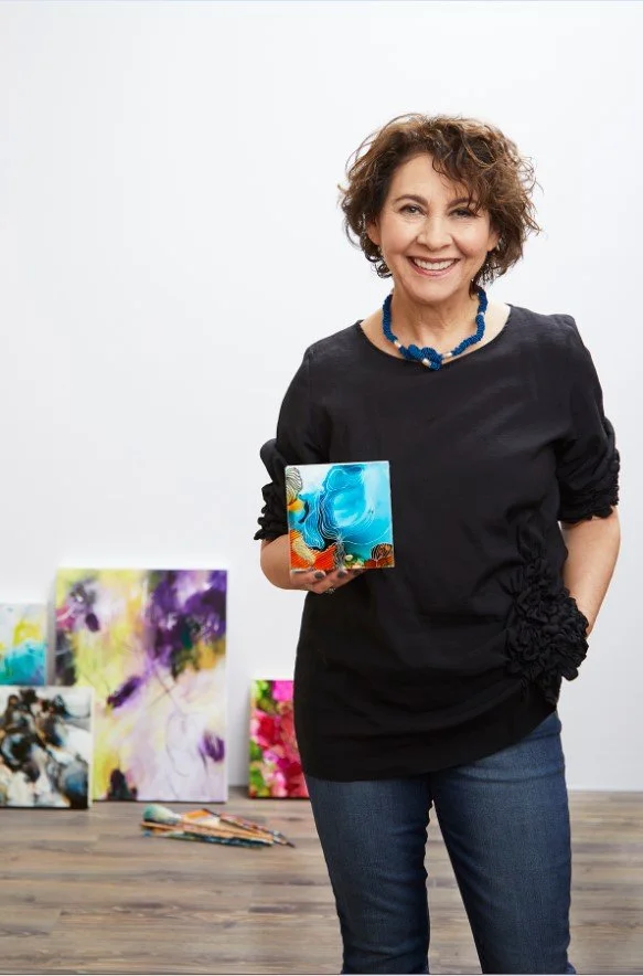 Lynda Goldman artist holding small painting