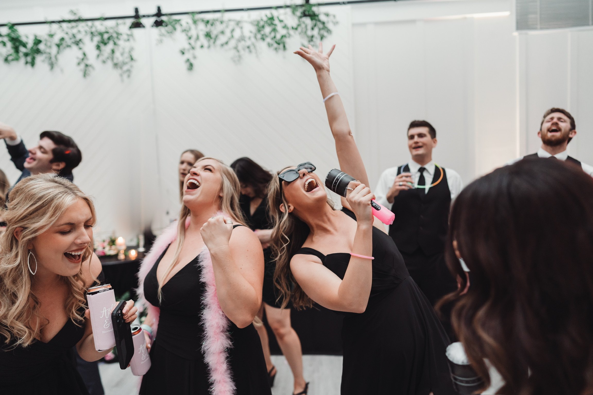 Girls on wedding dance floor in black bridesmaids dresses dancing to Move DJ music