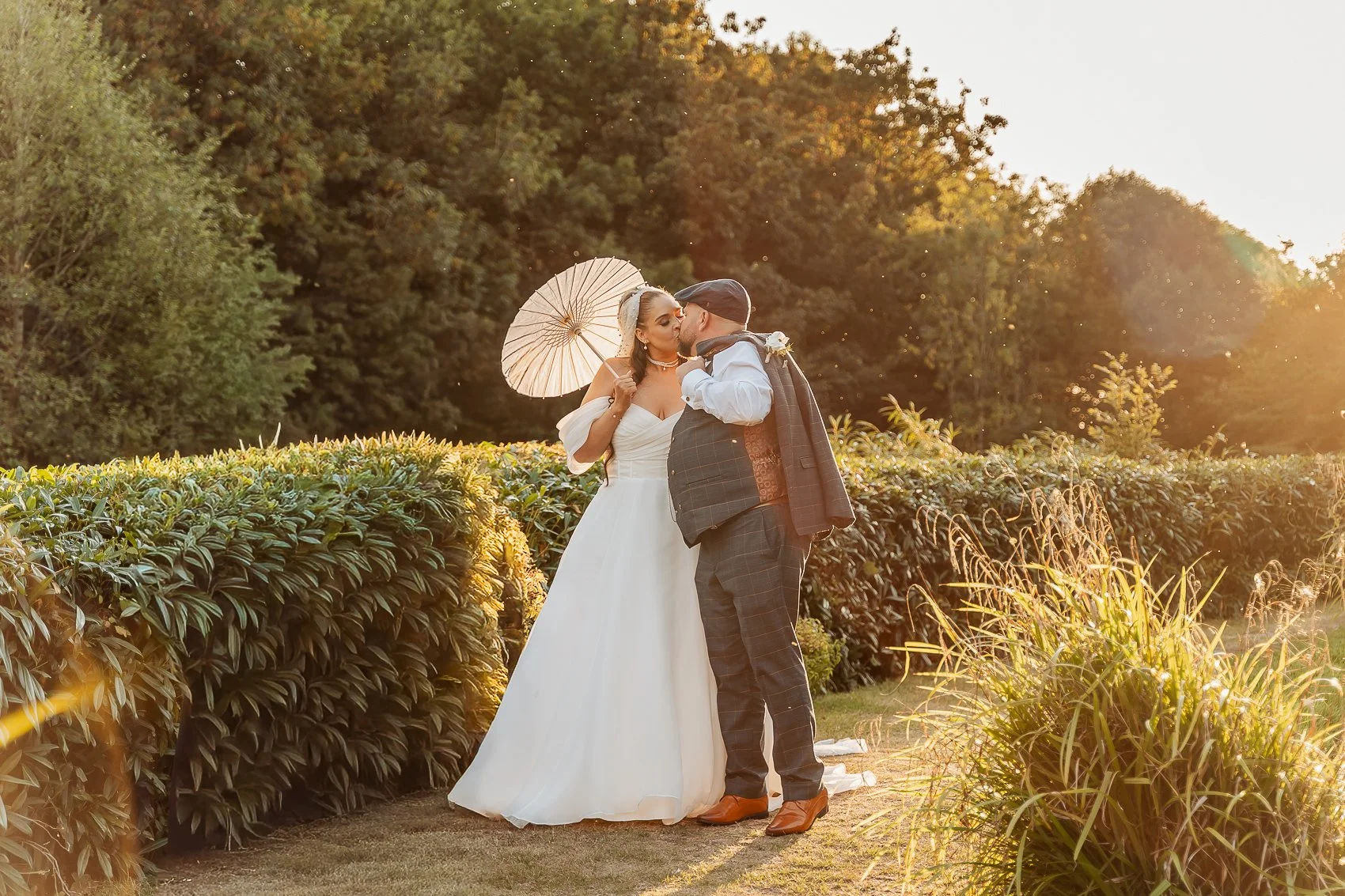 028-cadbury-house-wedding-golden-hour-kiss-parasol.jpg