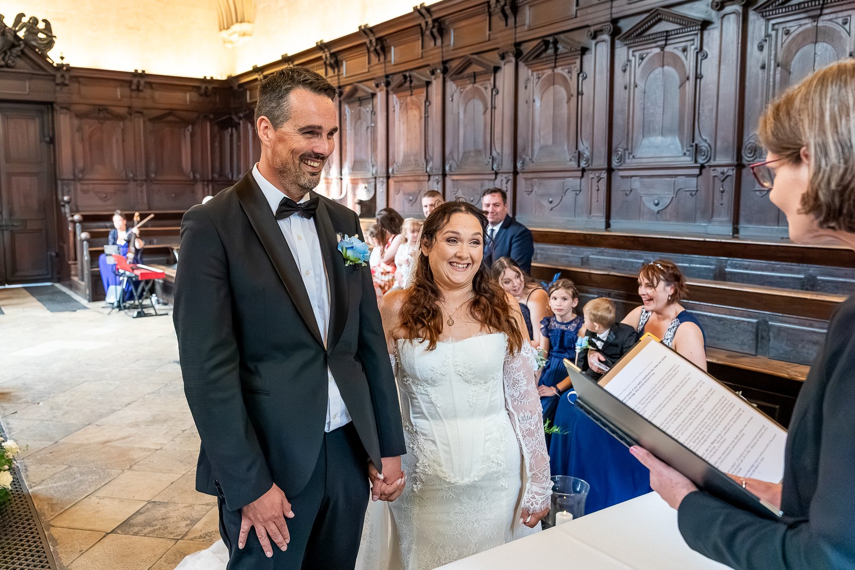 222-joe-stacey-bride-groom-laughing-bodleian-wedding-ceremony.jpg