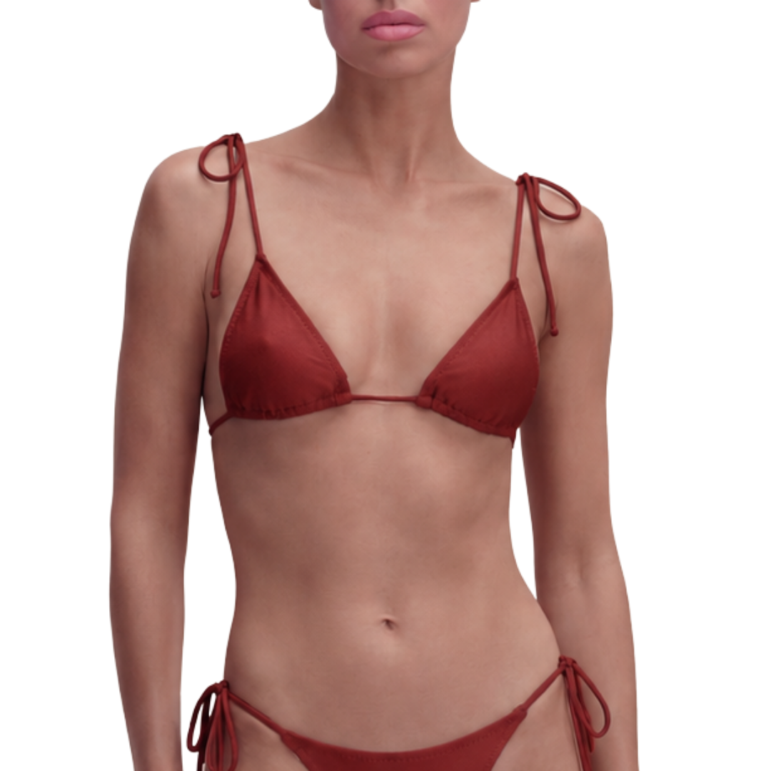 Unpadded triangle bikini top in a deep red spice tone. Natural second-skin fit, streamlined silhouette. Ethical luxury swimwear.