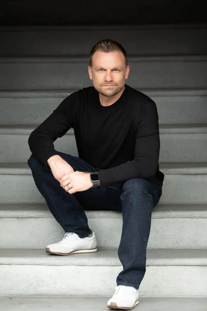 Male bearded entrepreneur coach sits on staircase