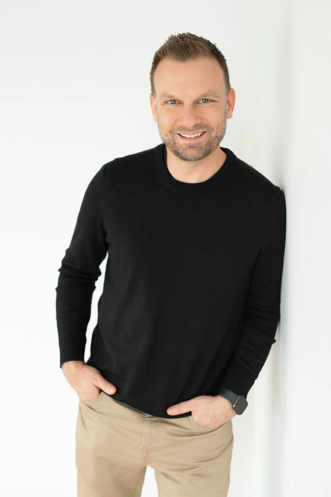 Relaxed lifestyle headshot of male entrepreneur in black sweater — personal branding photographer Southern California