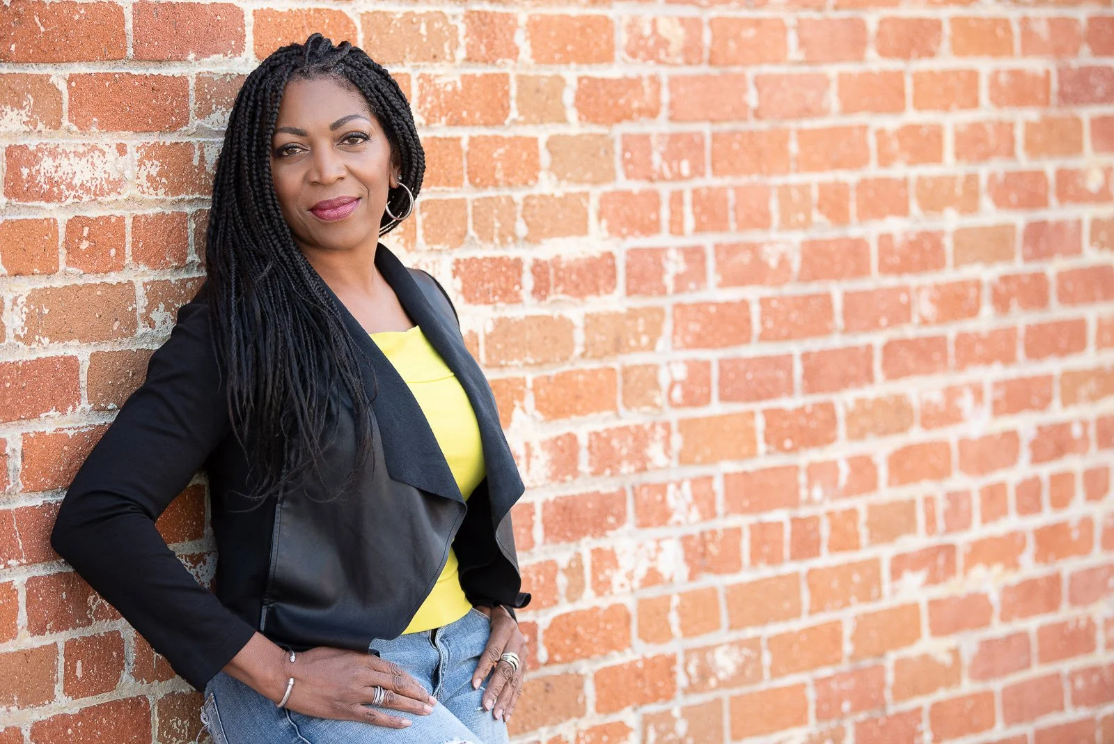 Environmental business headshot of female professional outdoors by brick wall — branding portrait San Gabriel Valley