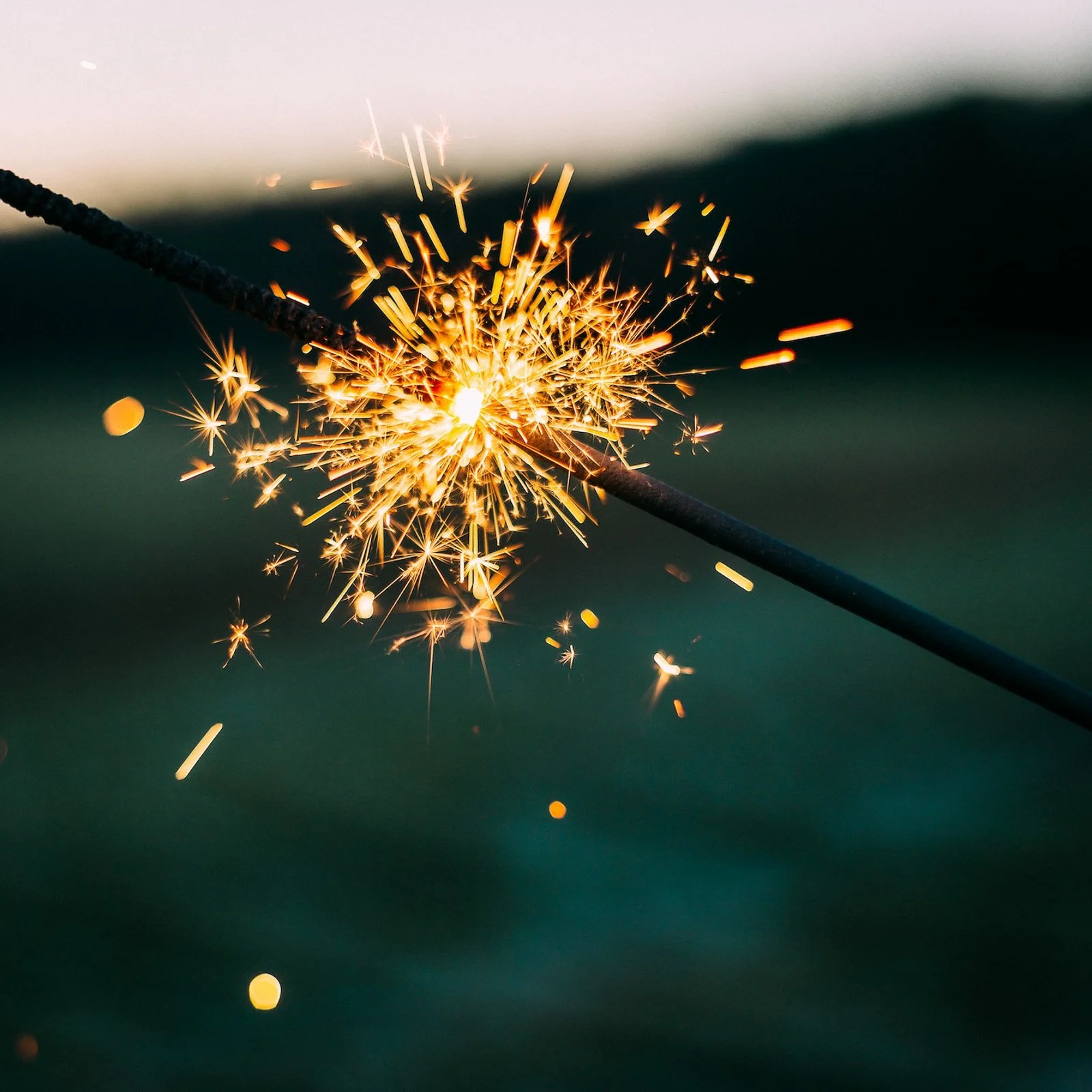 Sparkler lit up at twilight to light up your brand