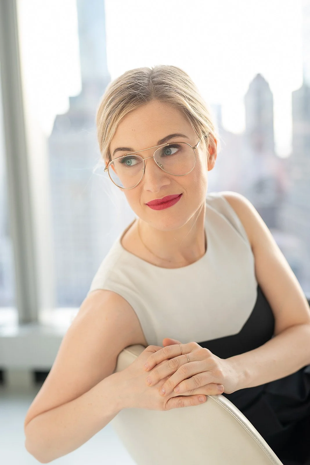 Modern executive headshot of female founder in bright window light — NYC corporate portrait photographer