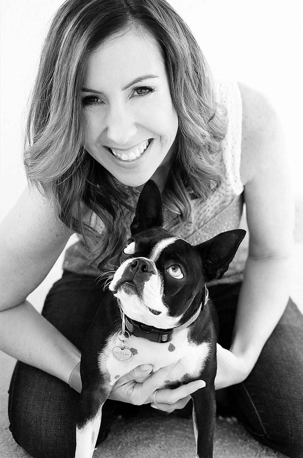 Black and white lifestyle headshot of female business owner holding dog — personal brand photography Los Angeles