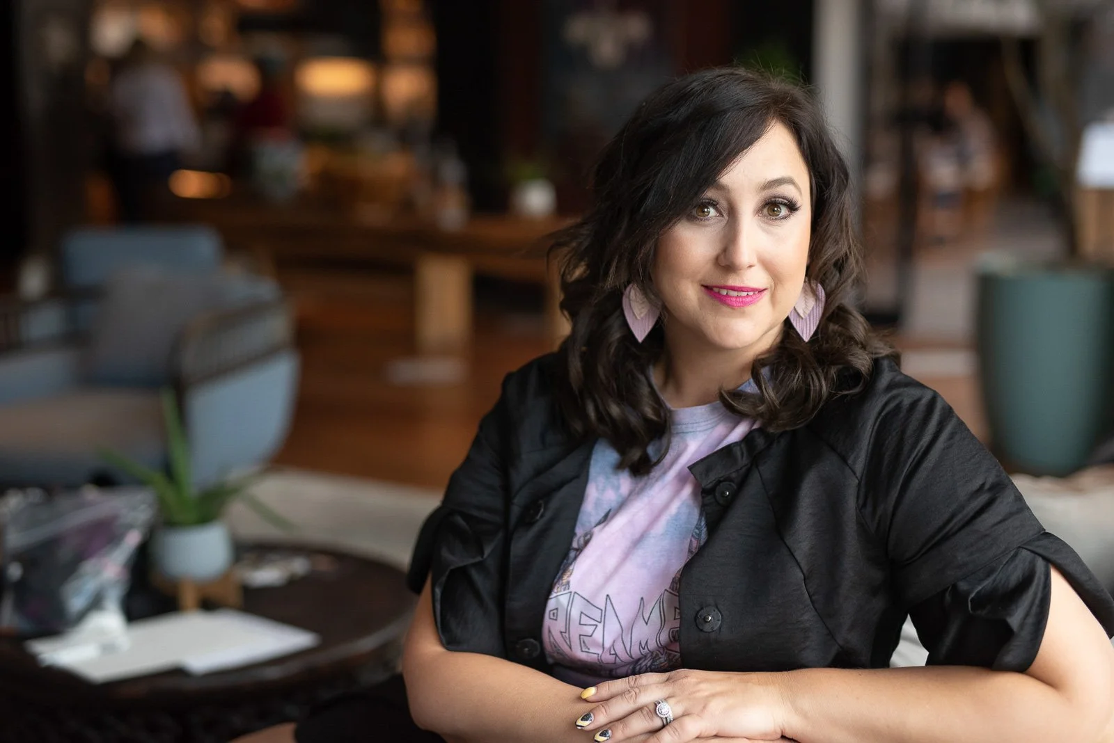 Corporate headshot of female consultant seated in upscale restaurant setting — professional portrait Claremont CA